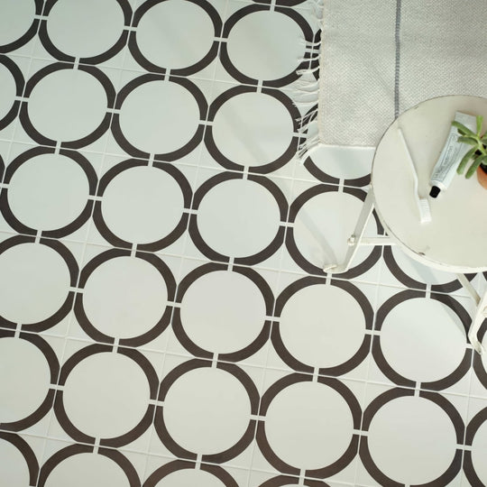 White and black circular patterned floor tiles from neisha crosland tulia hula hoop black collection