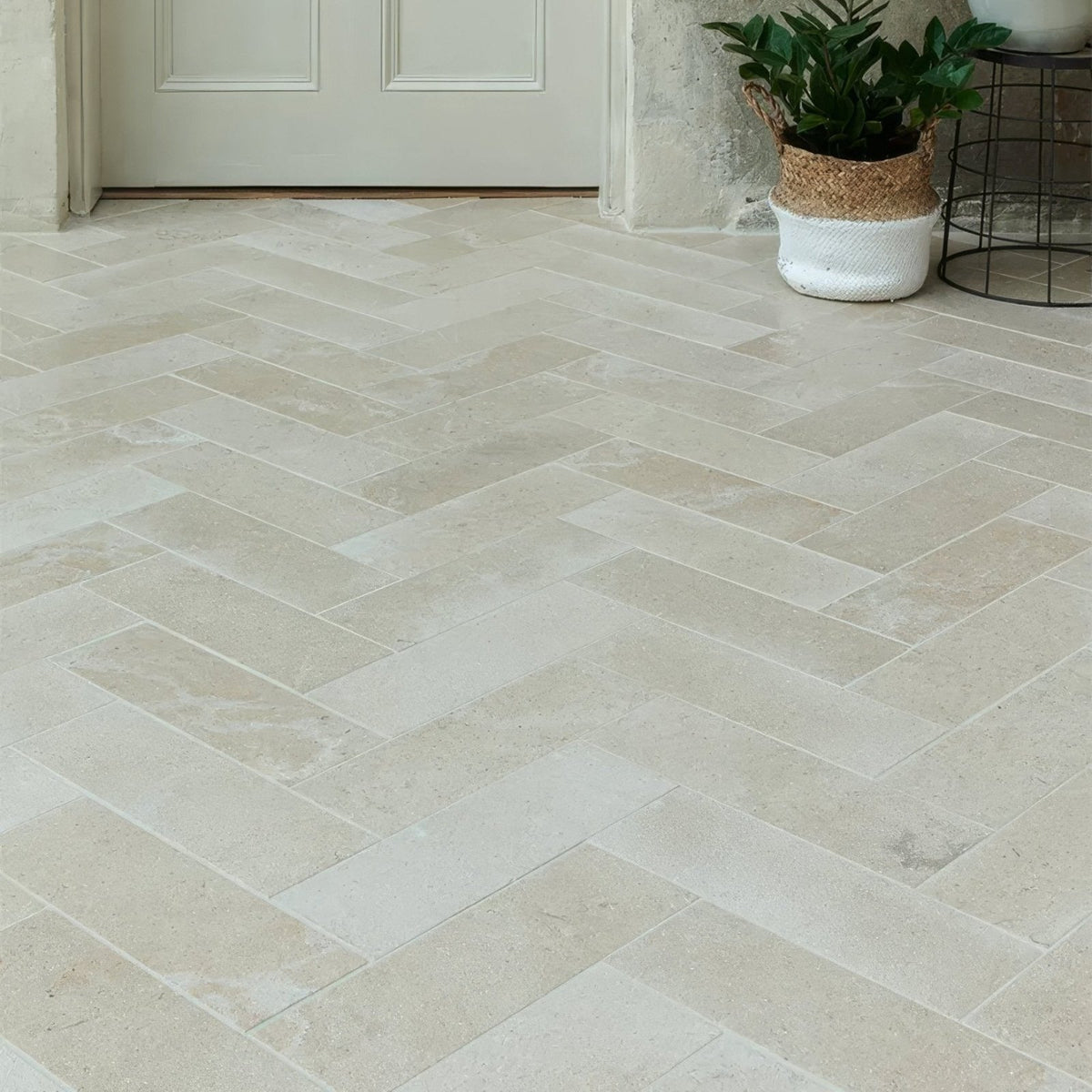 Beige herringbone patterned buscot limestone brick velvet finish stone floor tiles with a smooth texture