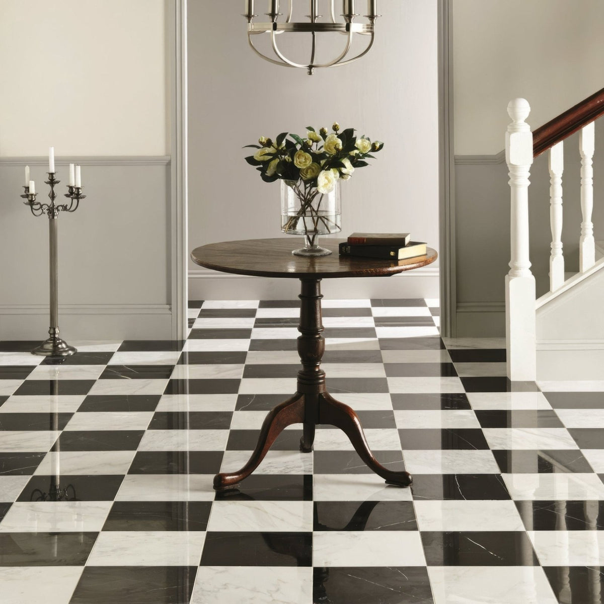 Nero Polished Marble black marble tiles with a round table and vase of roses