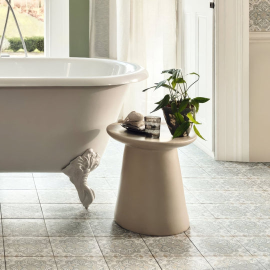 Beige ceramic pedestal table with smooth matte finish and tapered design shown with nina campbell jodhpur aqua porcelain tile