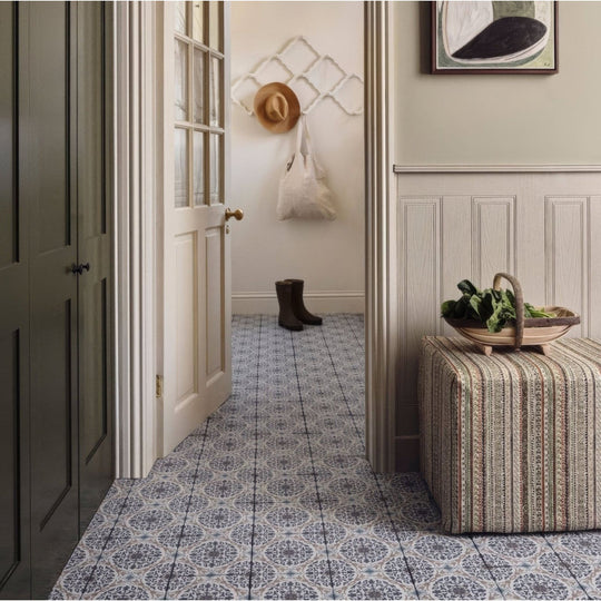 Patterned blue and white porcelain floor tiles with ornate design from nina campbell la moulade indigo collection