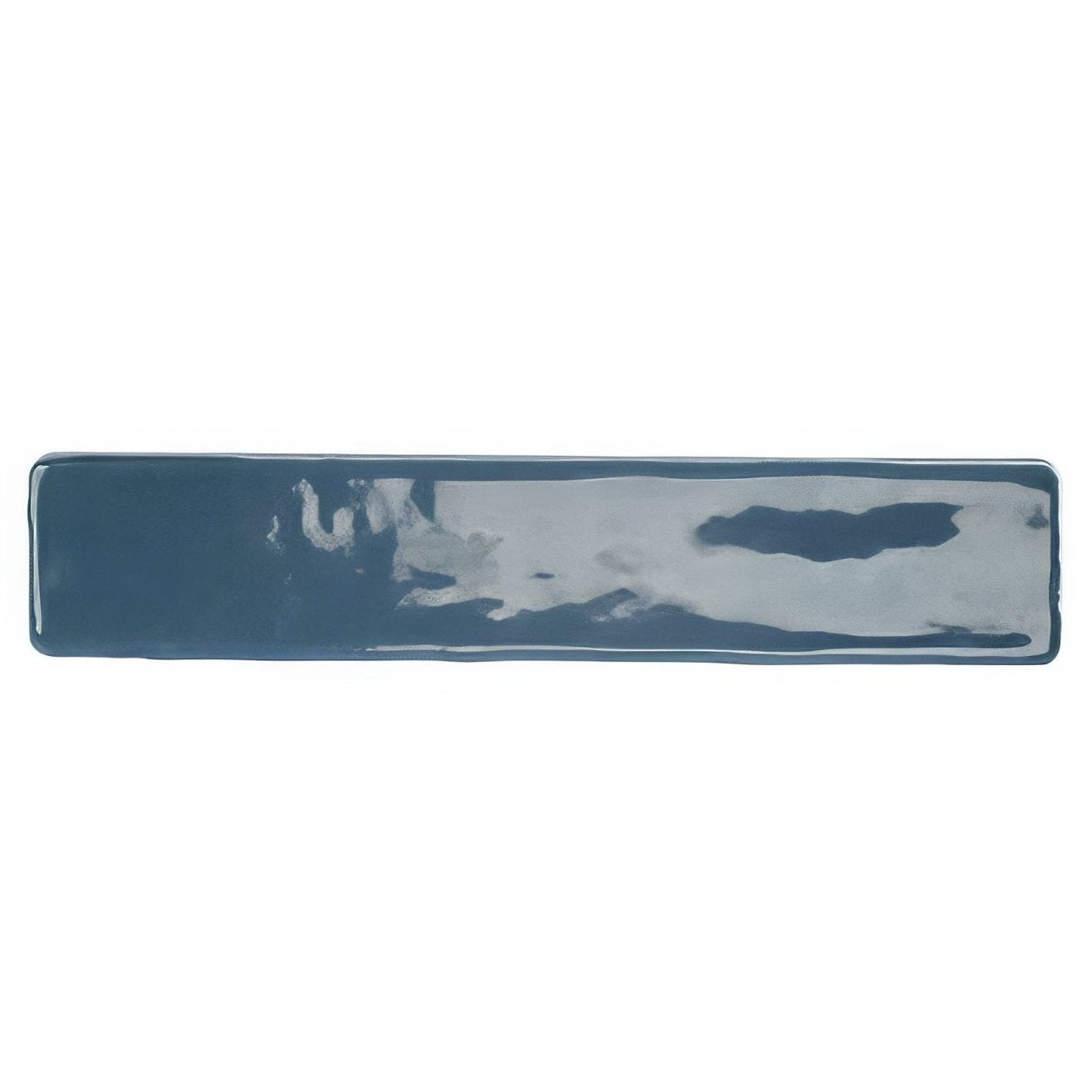 A rectangular ceramic wall tile with glossy deep blue indigo glaze and subtle grayish-white abstract markings by nina campbell