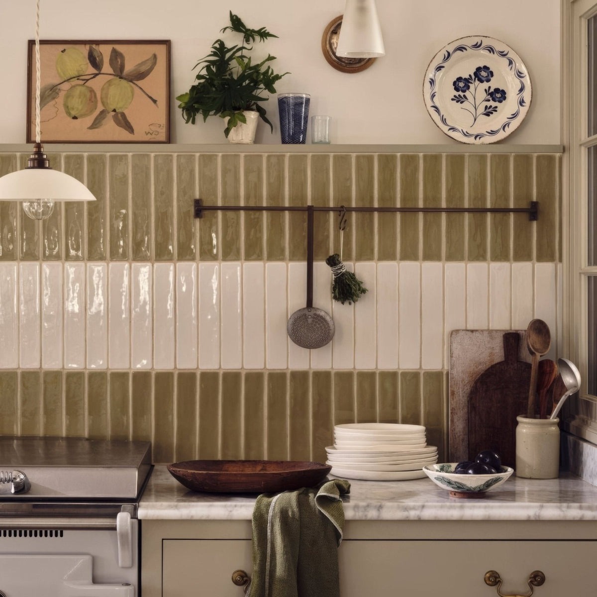 Olive-green and white vertical subway tile backsplash featuring nina campbell rivage ivory glazed wall tile design