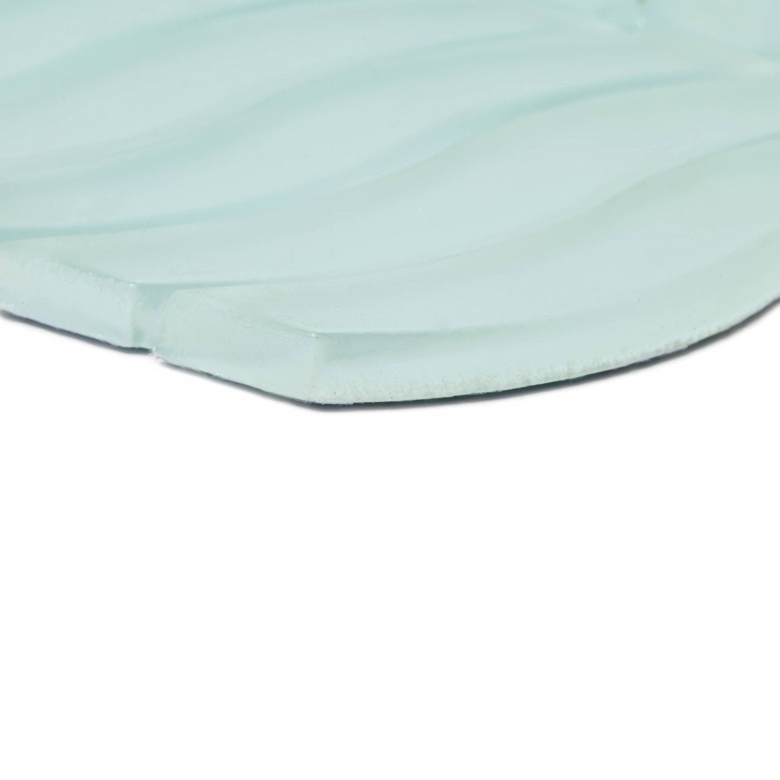 A translucent light green nordic glass bergen fjord mosaic tile with subtle wavy texture and rounded edges