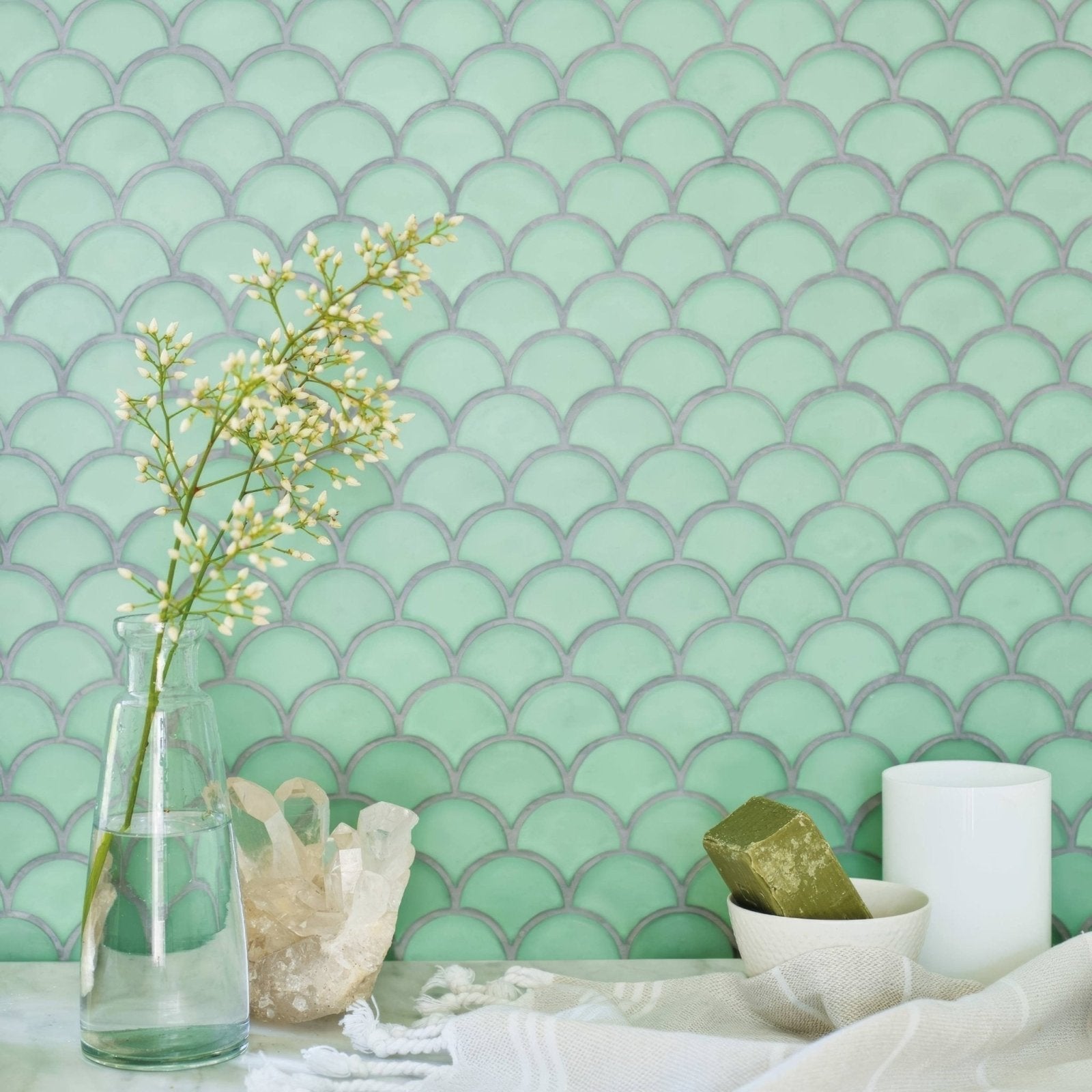 Nordic Glass Tromso Fjord Mosaic mint green fish-scale glass mosaic with a glass vase of white flowers