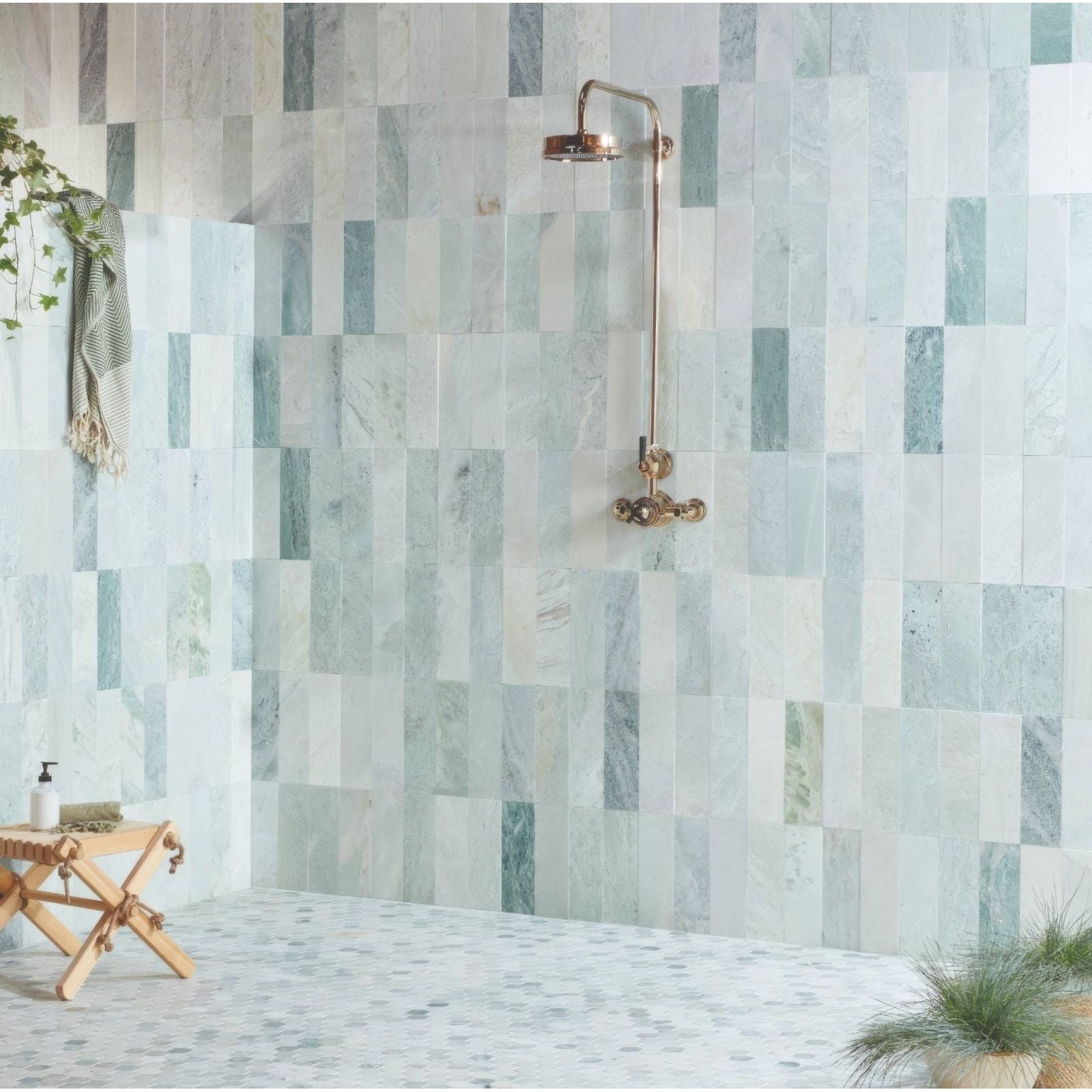 North Haven Rectangle Marble Tile 10x30cm green and grey marble tiles with a brass showerhead