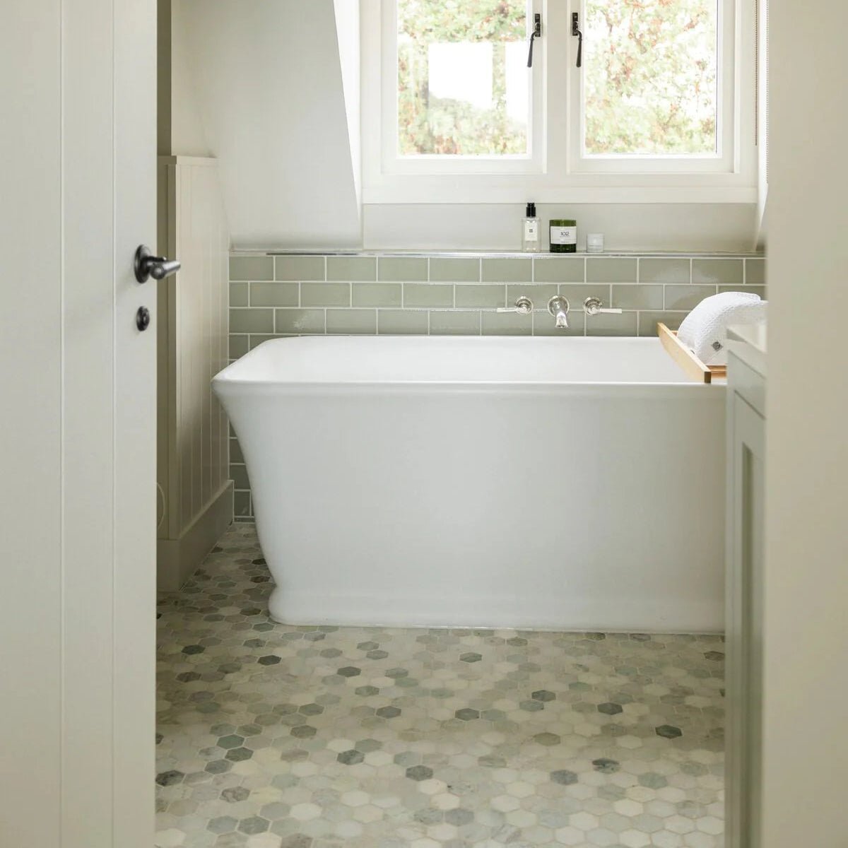 North Haven Hexagon Marble Mosaic Tile grey and white hexagonal marble mosaic with a white freestanding bathtub