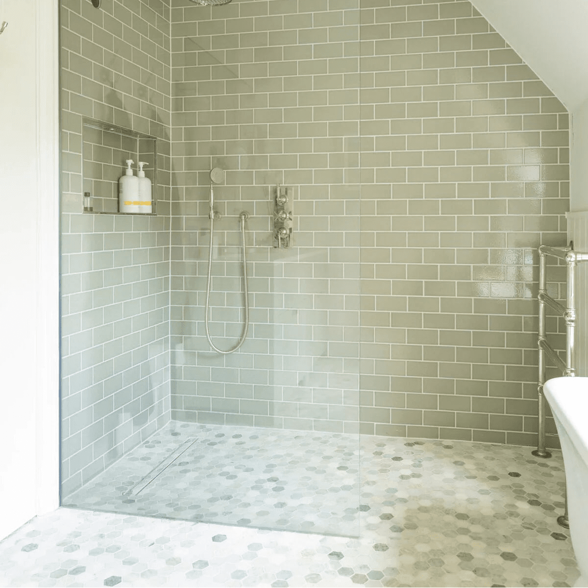 North Haven Hexagon Marble Mosaic Tile grey and white hexagonal marble mosaic in a shower with a glass door