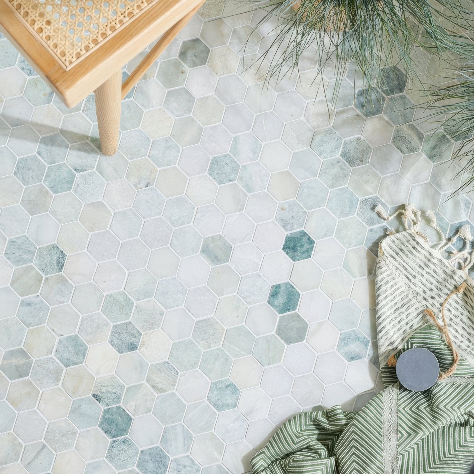 North haven hexagon marble mosaic tile featuring soft white and muted teal hexagonal marble tiles on a textured floor