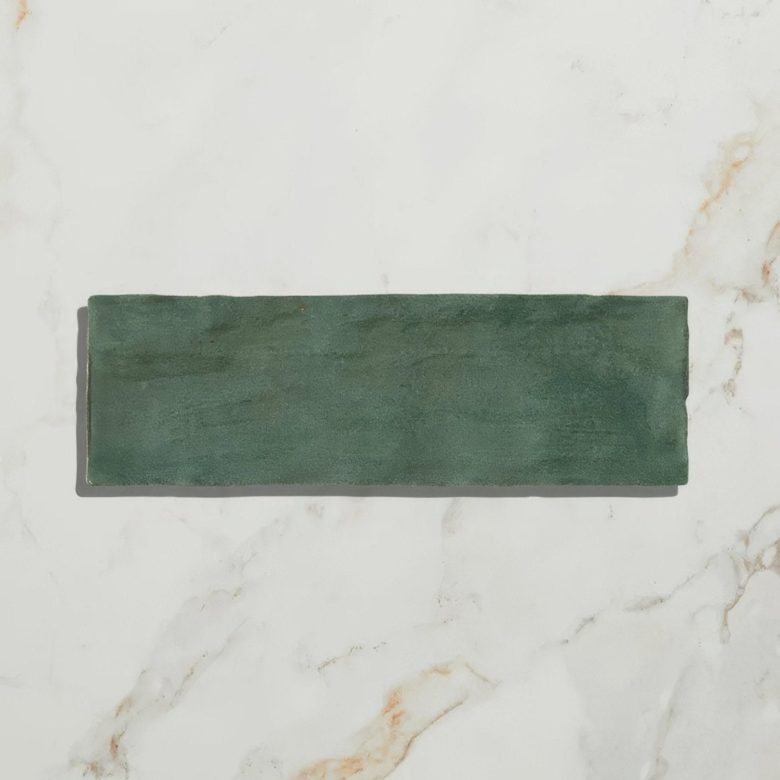 A rectangular matte-finished dark green ceramic tile with subtle texture from Oasis Ceramic Green Gloss collection