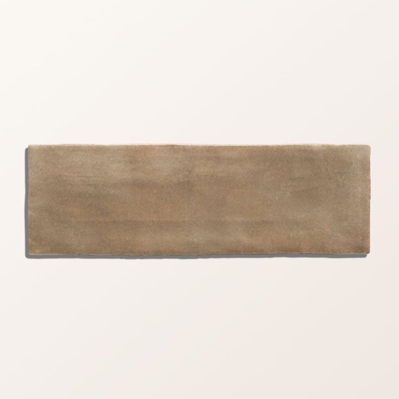 A rectangular taupe-colored oasis veloute ceramic tile with a matte slightly textured surface