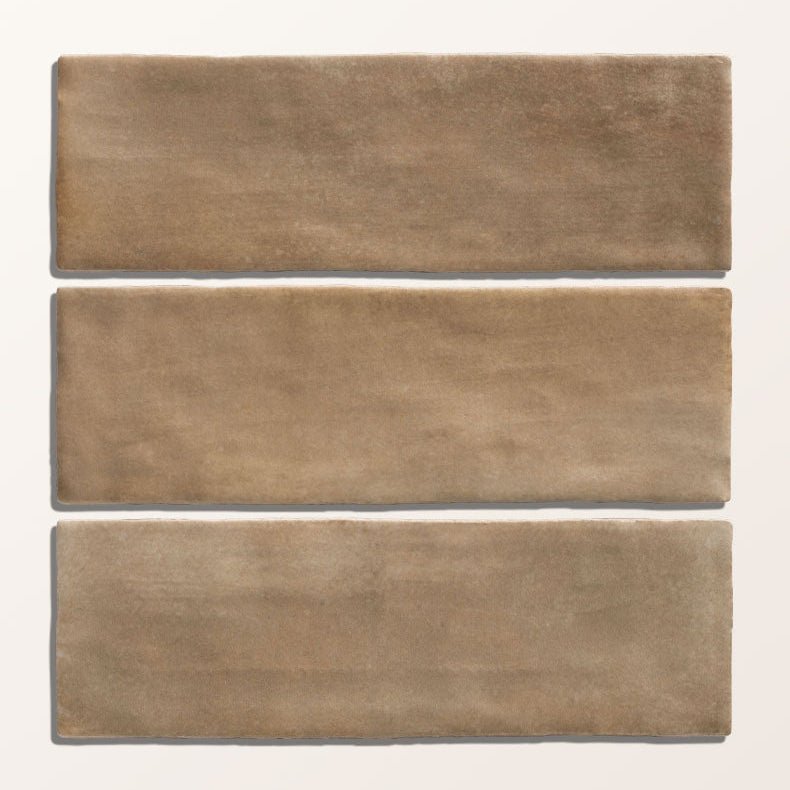 Three rectangular taupe ceramic tiles with a matte textured finish from oasis veloute ceramic tan matt collection