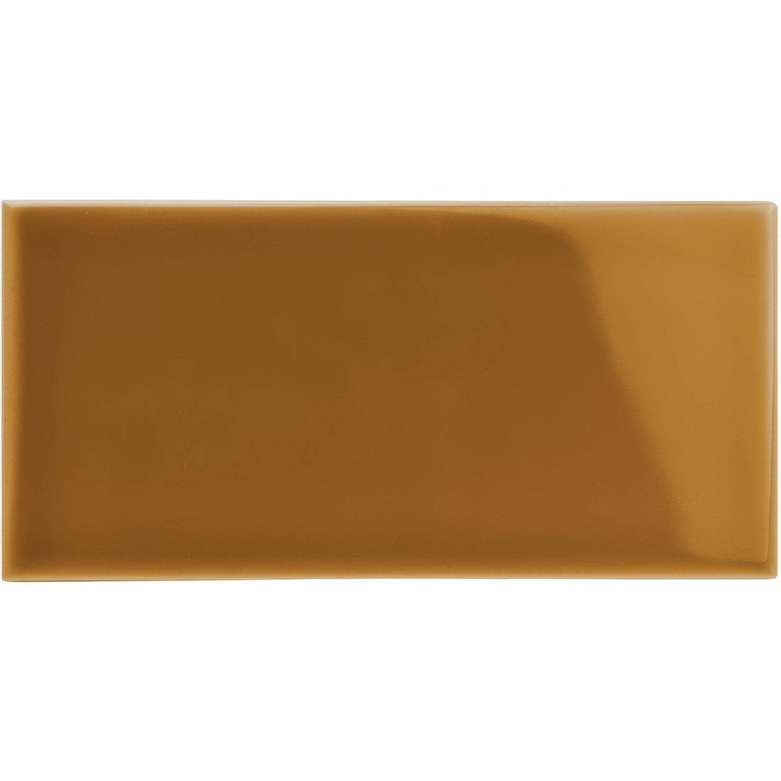 A glossy caramel-colored ochre half tile made of rectangular ceramic with a smooth and uniform surface