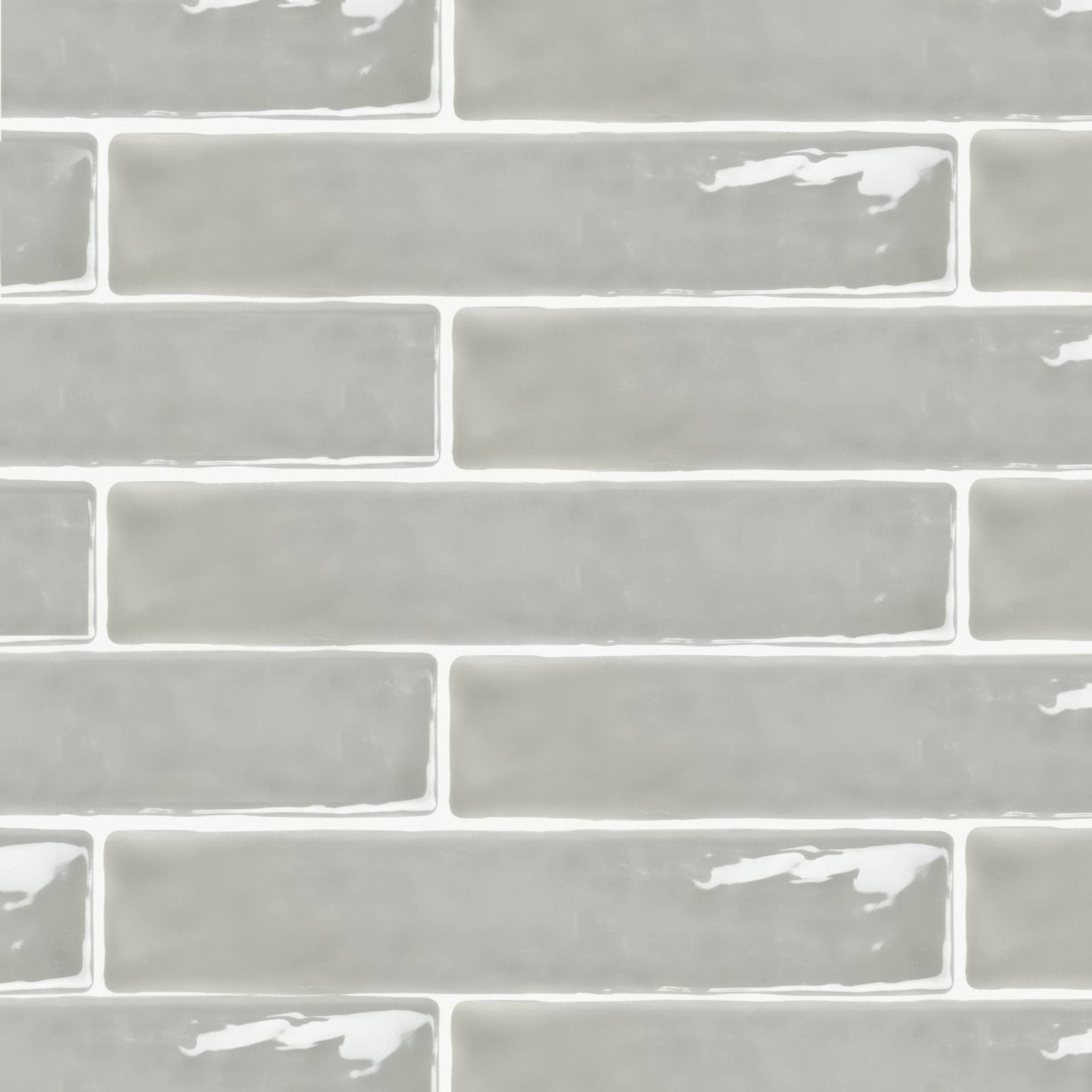 Onda chamelon wall tiles in gray glass subway style with a glossy finish and subtle white grout lines