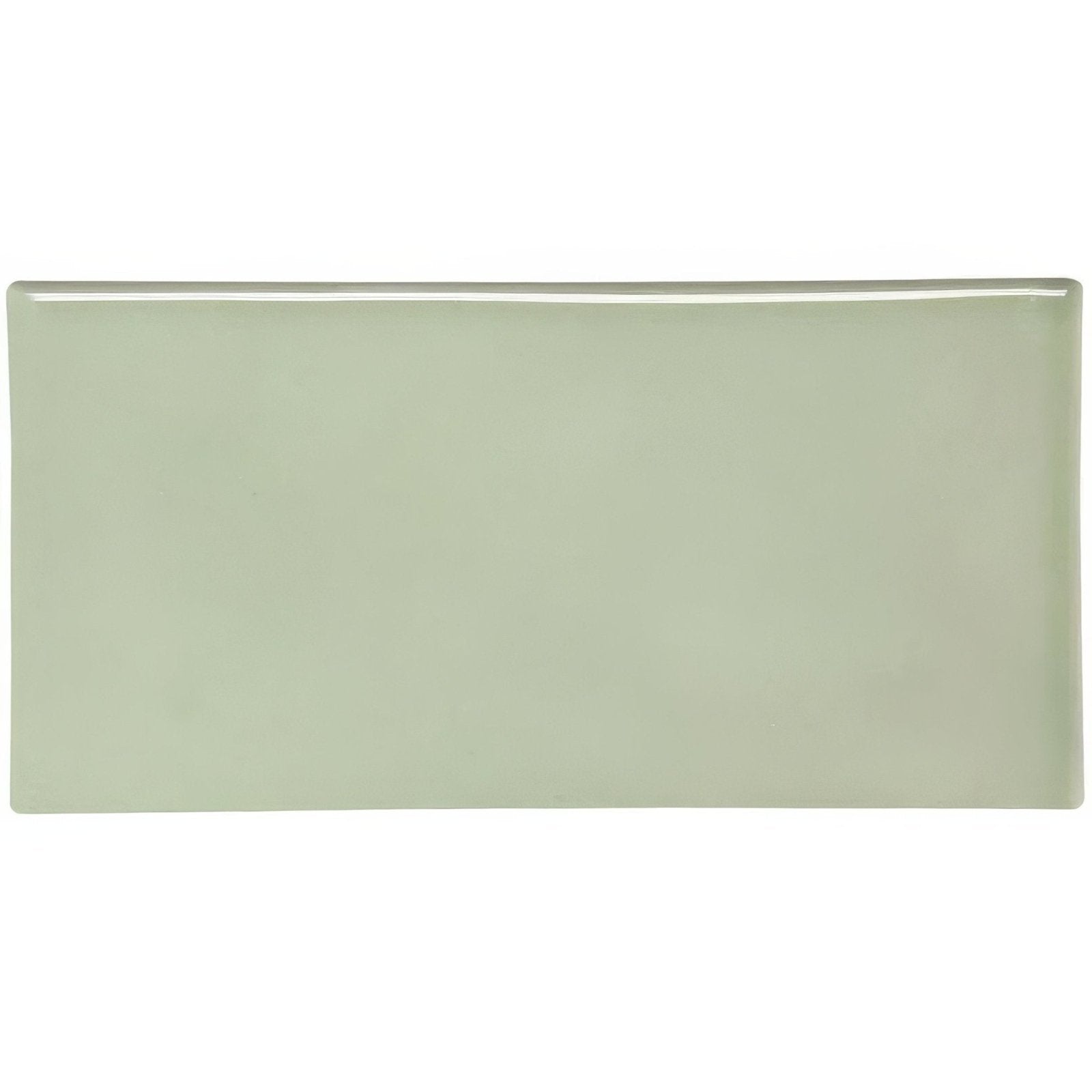 A sleek rectangular ceramic orford half tile with smooth matte sage green finish and rounded edges