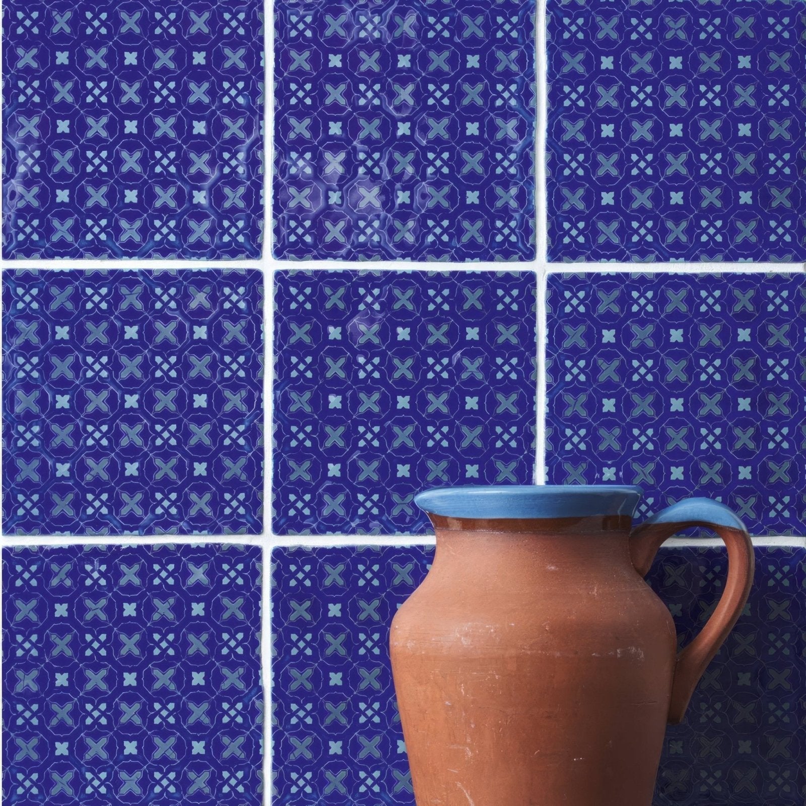 Earthenware pitcher ormeaux on amun with terracotta body and light blue glazed rim and handle