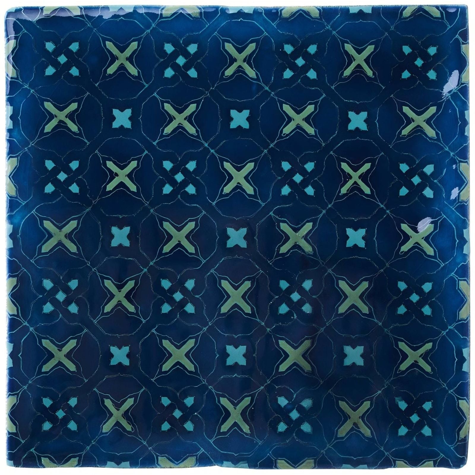 Square ceramic tile ormeaux on bastille with glossy deep blue surface and light green x shaped motifs outlined in white