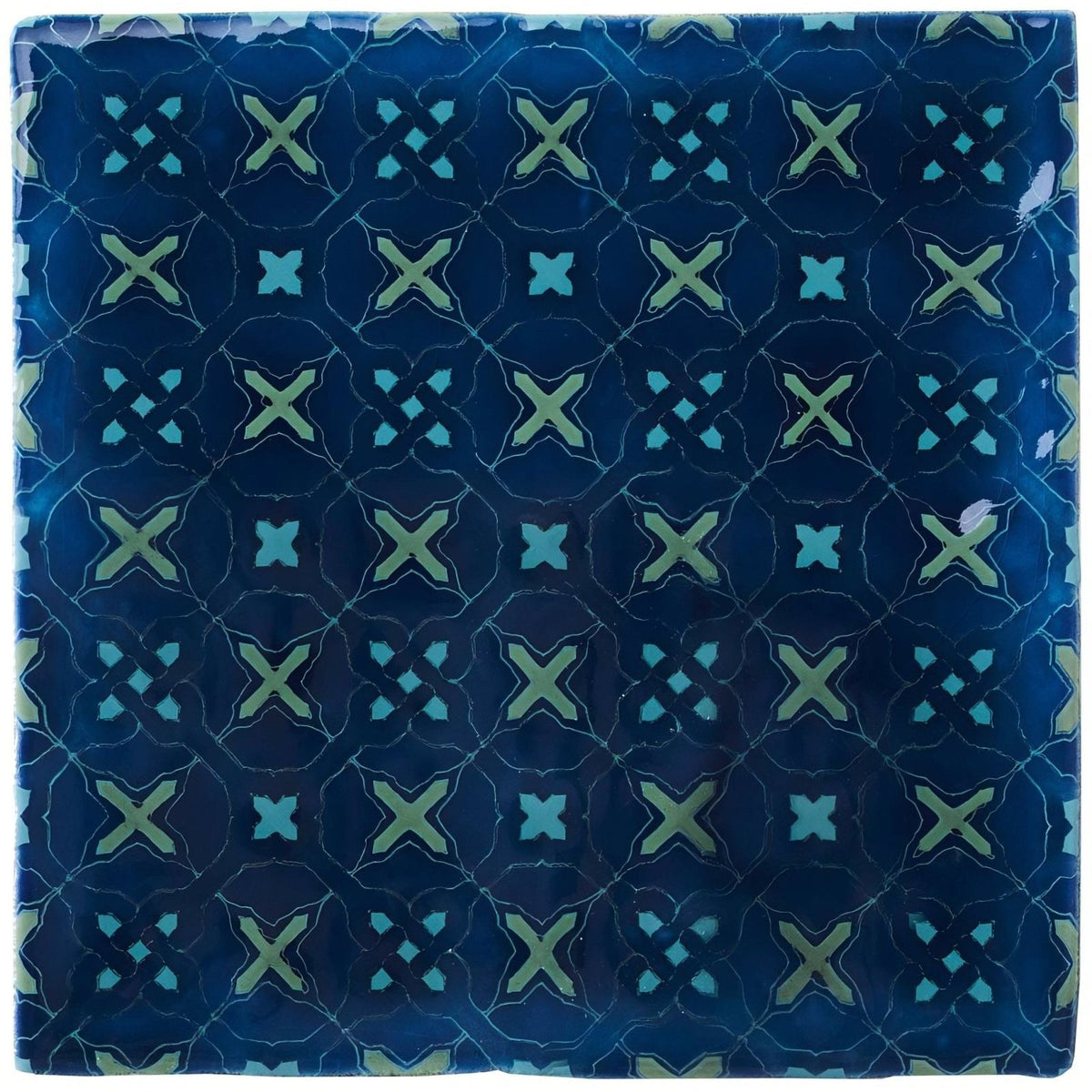 Square ceramic tile ormeaux on bastille with glossy deep blue surface and light green x shaped motifs outlined in white