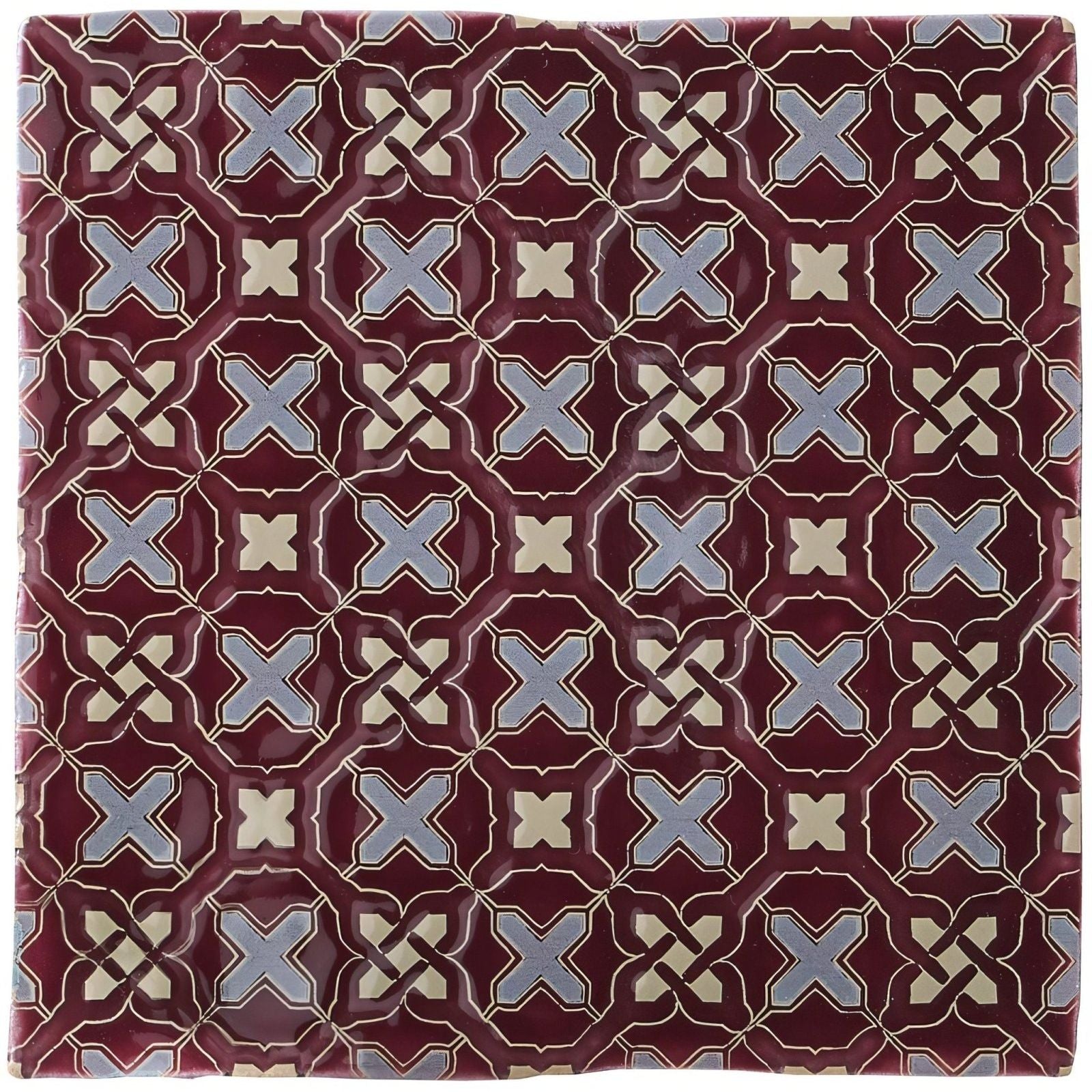 Ormeaux on Blackberry maroon ceramic tile with repeating geometric pattern of light blue and cream interlocking x shapes