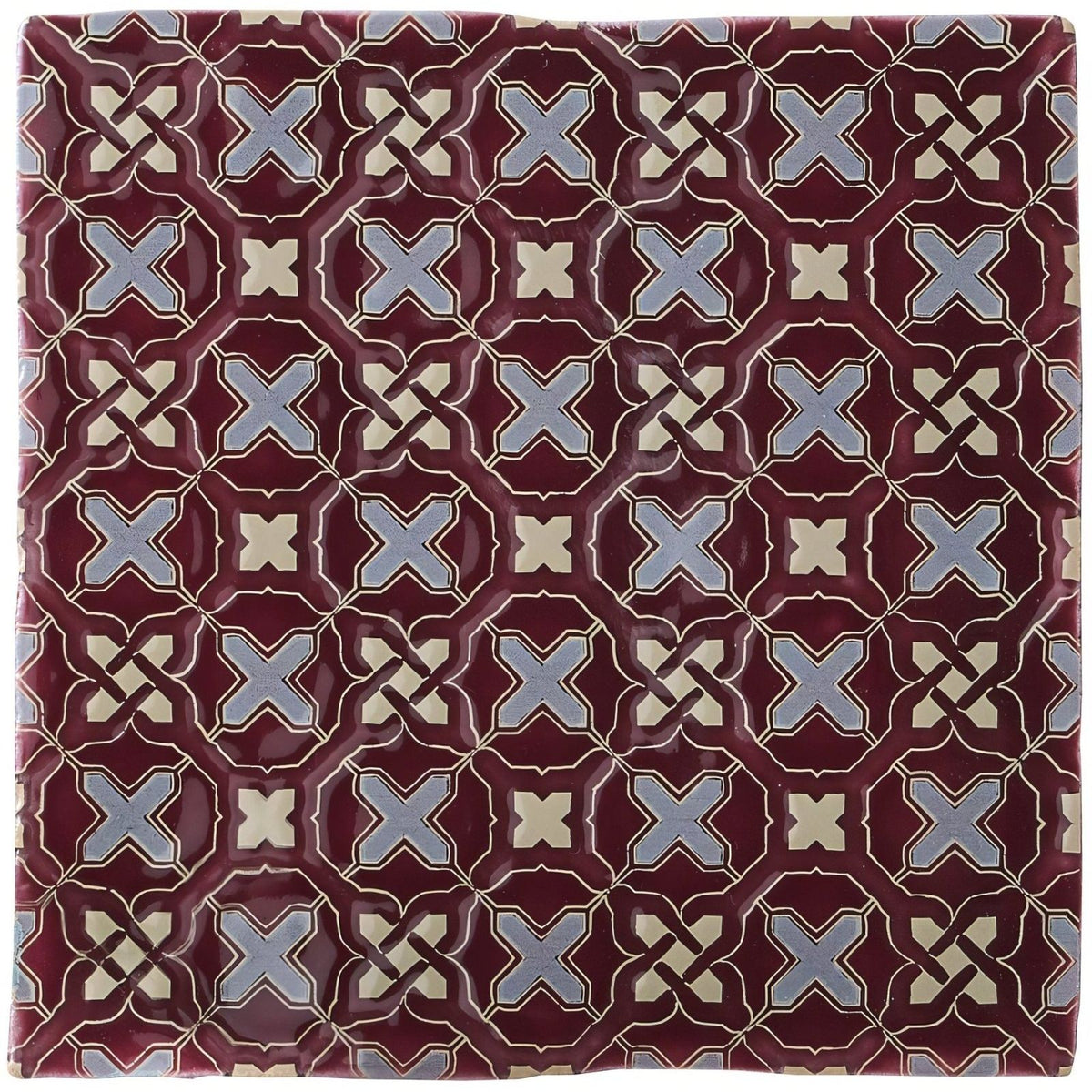 Ormeaux on Blackberry maroon ceramic tile with repeating geometric pattern of light blue and cream interlocking x shapes
