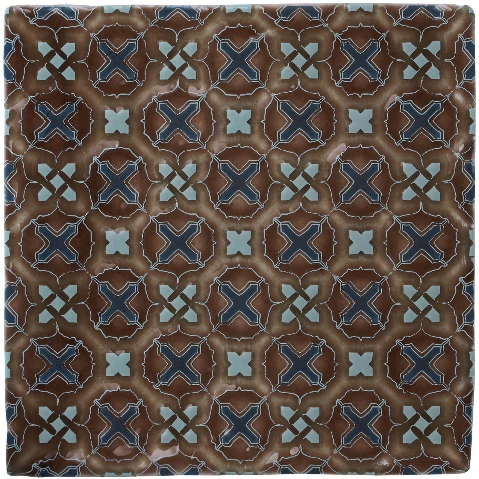 Brown ceramic tile ormeaux on chestnut with navy blue and light teal geometric cross pattern on textured earthy background