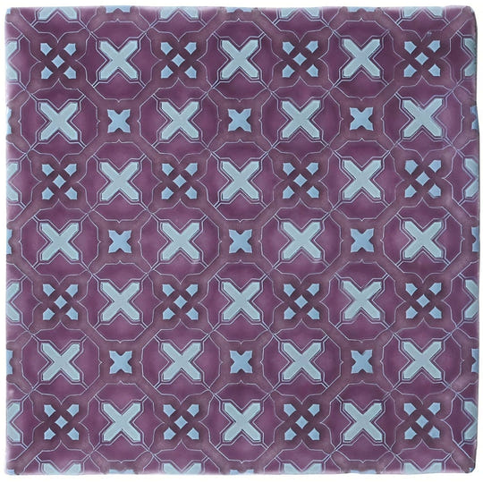 Purple ceramic tile ormeaux on glen with repeating geometric pattern of light blue x-shapes and diamond accents