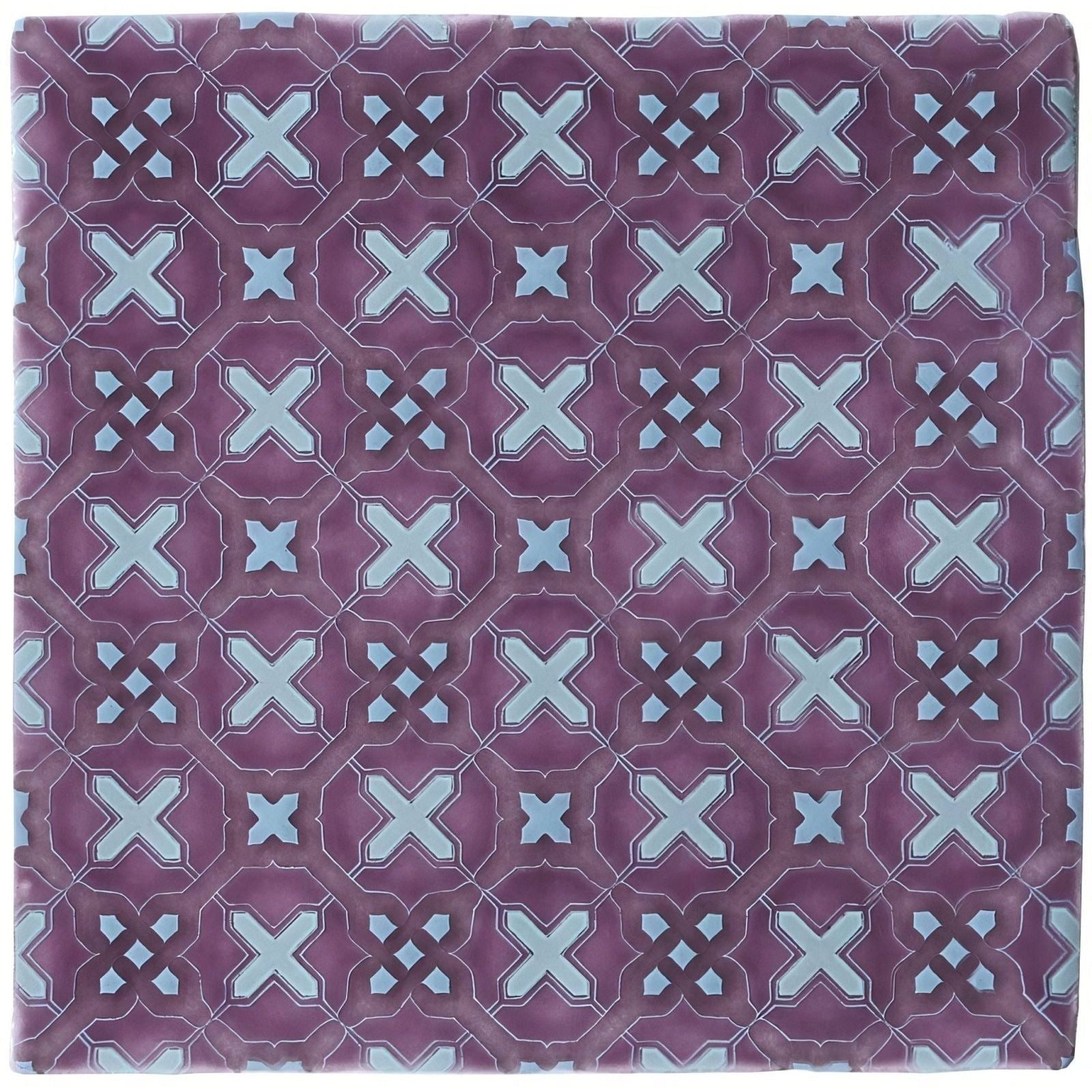 Purple ceramic tile ormeaux on glen with repeating geometric pattern of light blue x-shapes and diamond accents