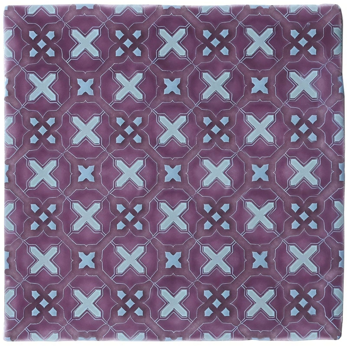Purple ceramic tile ormeaux on glen with repeating geometric pattern of light blue x-shapes and diamond accents