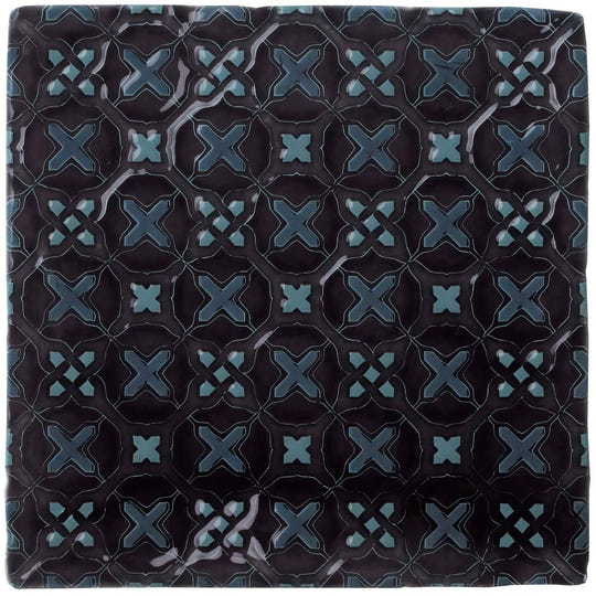 Dark blue ceramic tile ormeaux on sloe with glossy finish and intricate teal geometric x-shape pattern