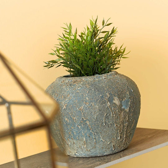 Oxford Ochre textured grayish blue ceramic planter with rustic finish holding a lush green artificial plant