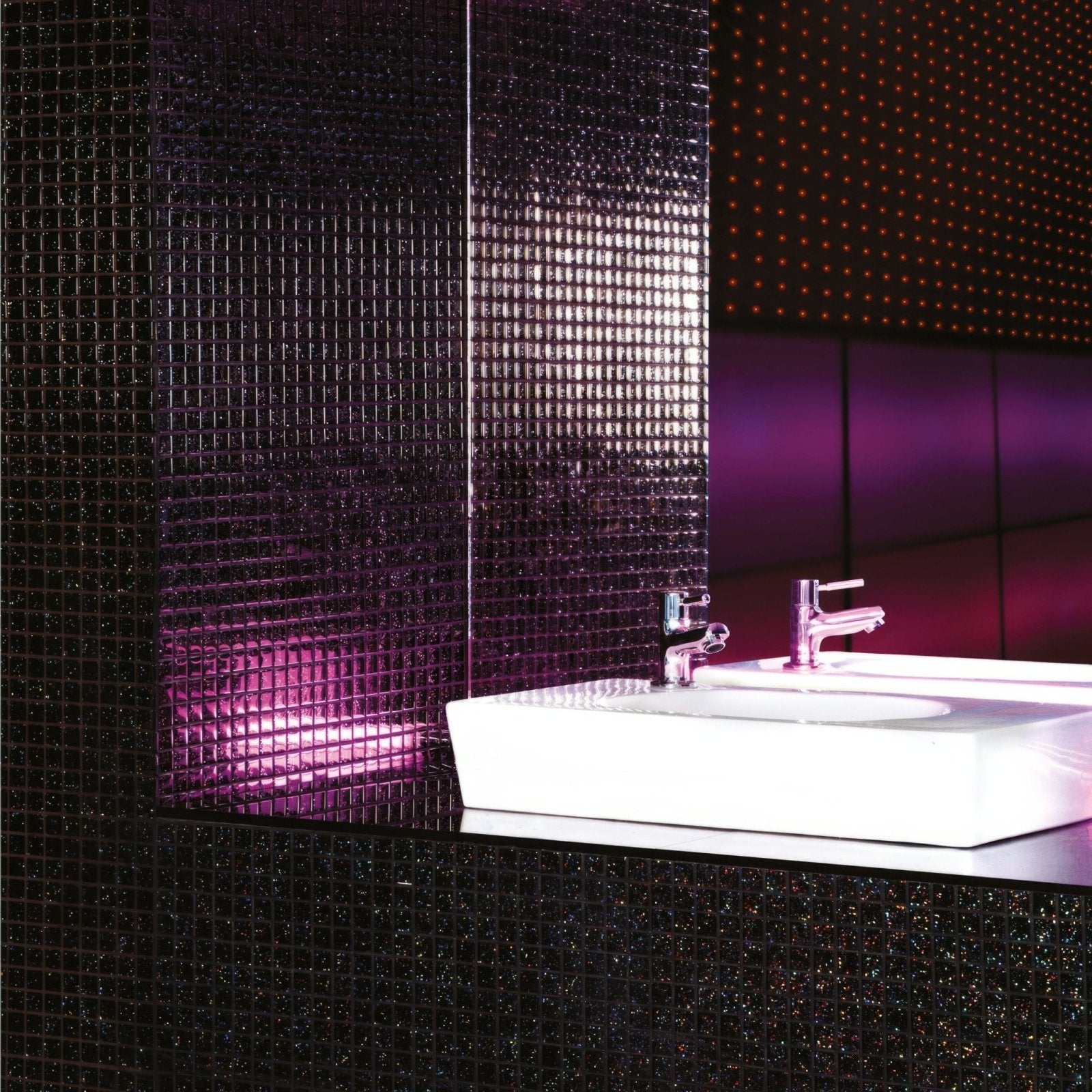 Pacha Glass Mosaic dark sparkling glass mosaic with a white sink and chrome taps
