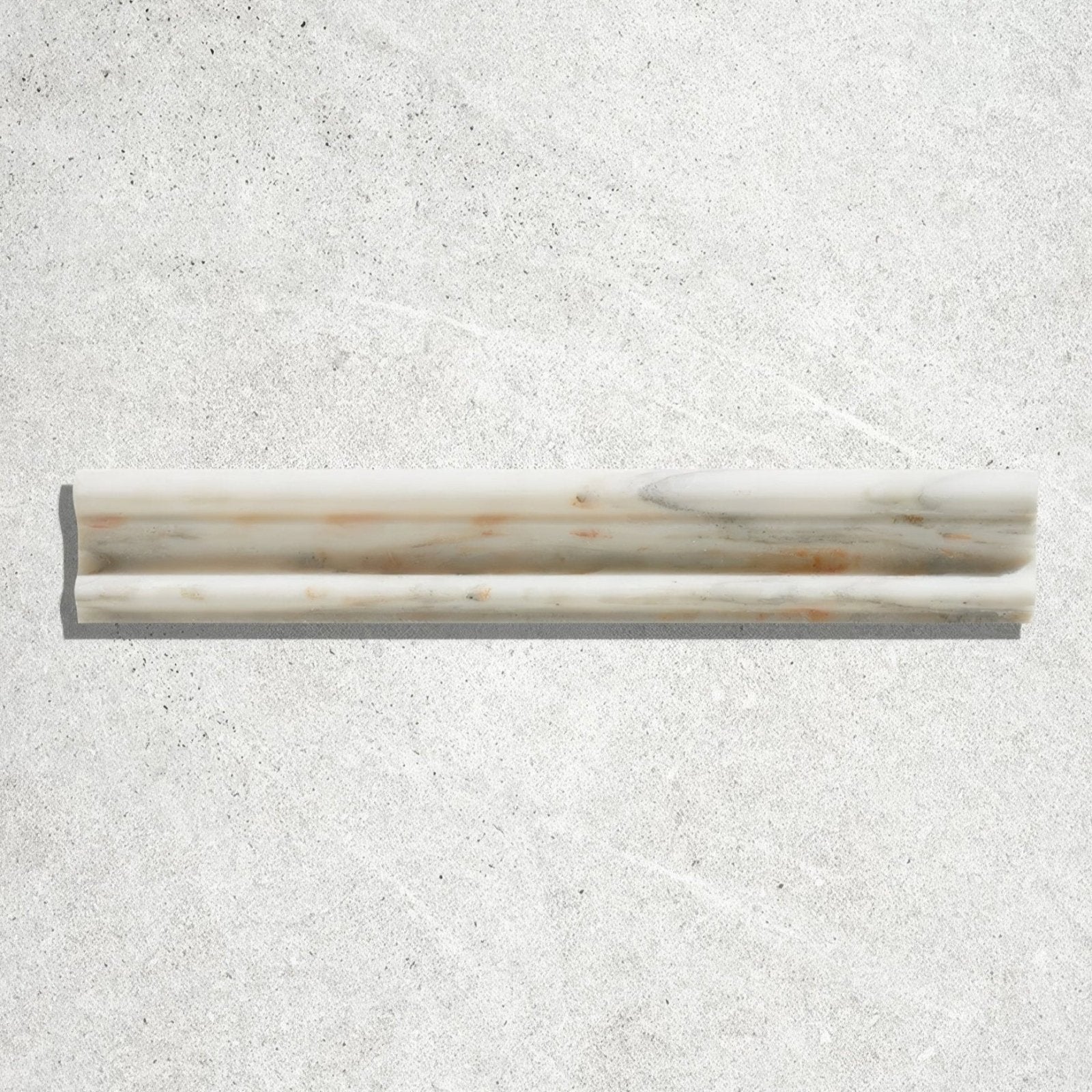 A sleek off-white Palazzo Oro marble honed moulding trim with subtle gray and rust-colored veining