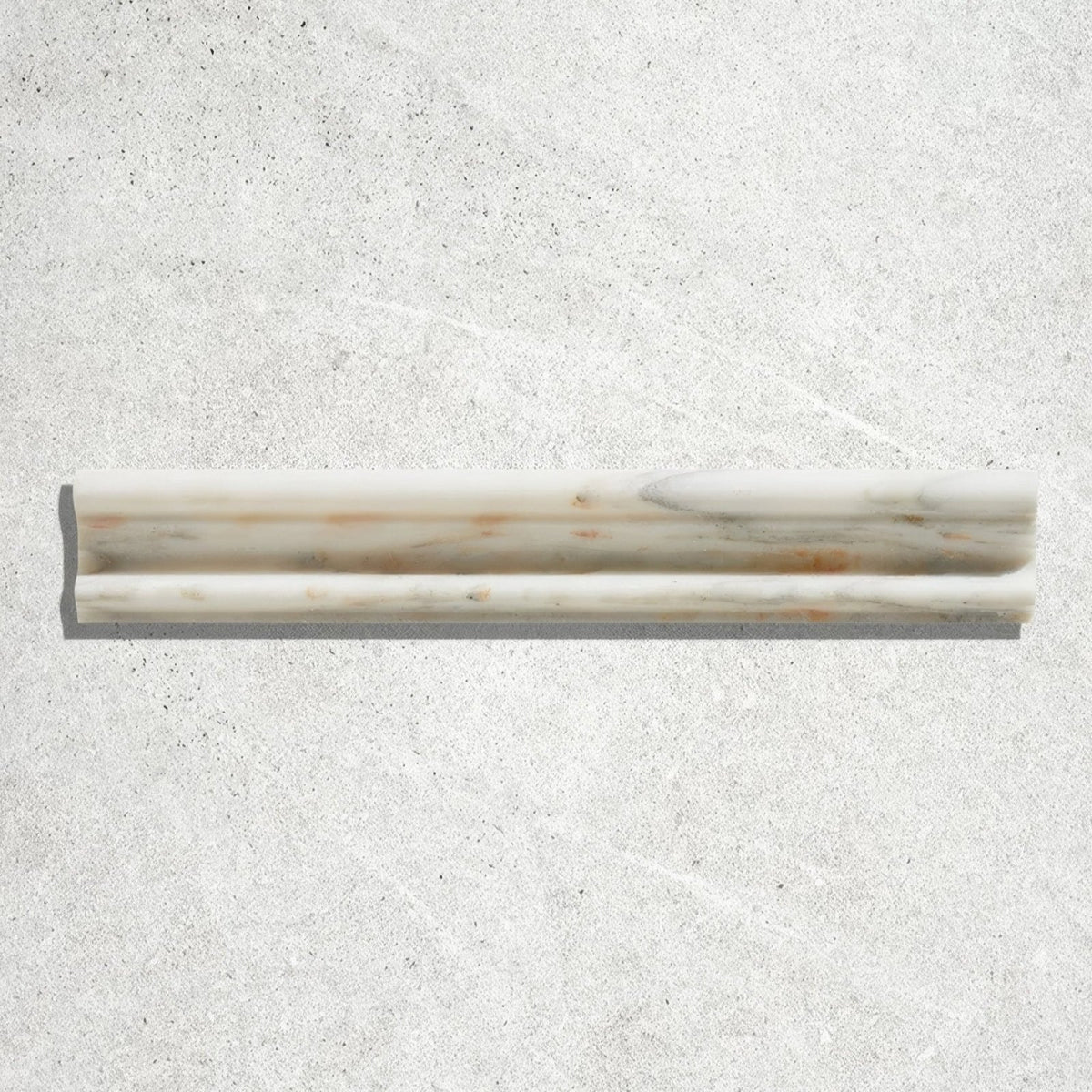 A sleek off-white Palazzo Oro marble honed moulding trim with subtle gray and rust-colored veining