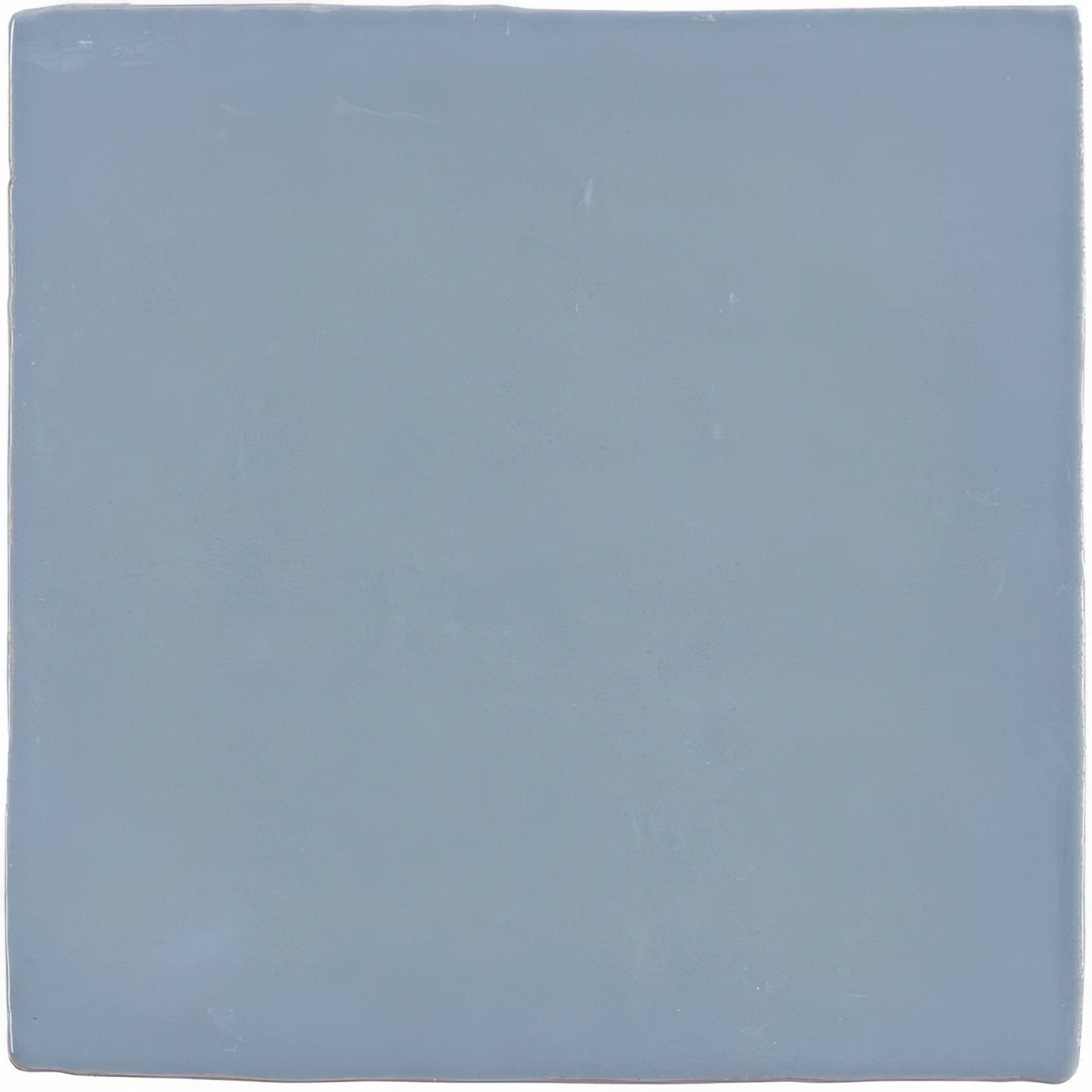 Pansy field tile is a square matte ceramic tile in a soft muted blue hue ideal for wall and floor use