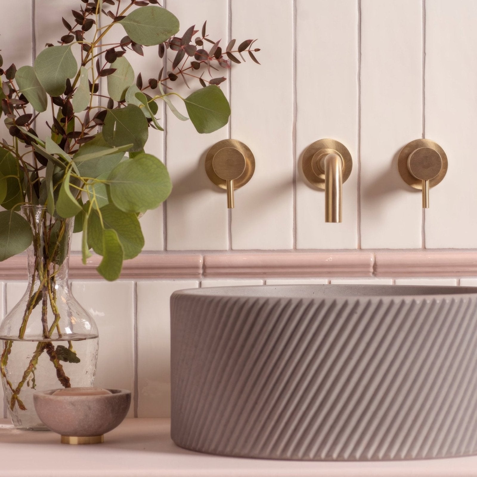 A matte gray concrete sink with diagonal ribbed texture featured in the papyrus large brick tile product line