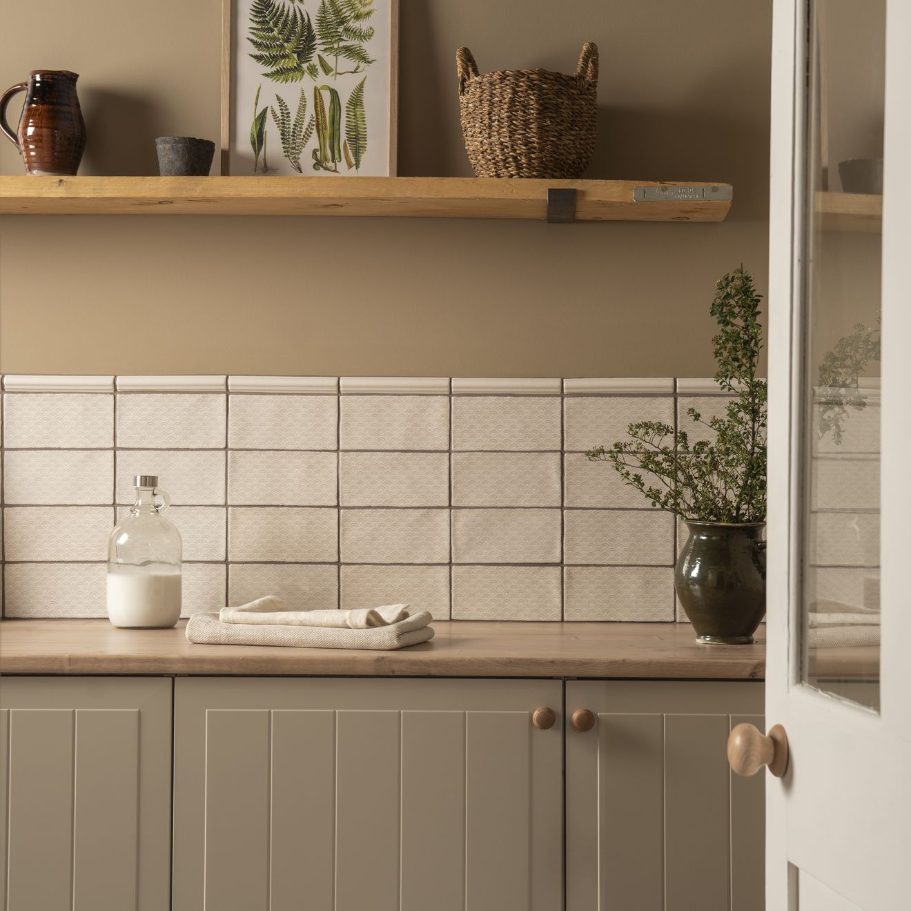 Beige rectangular papyrus ogee moulding tiles with a subtle textured surface used as a kitchen backsplash