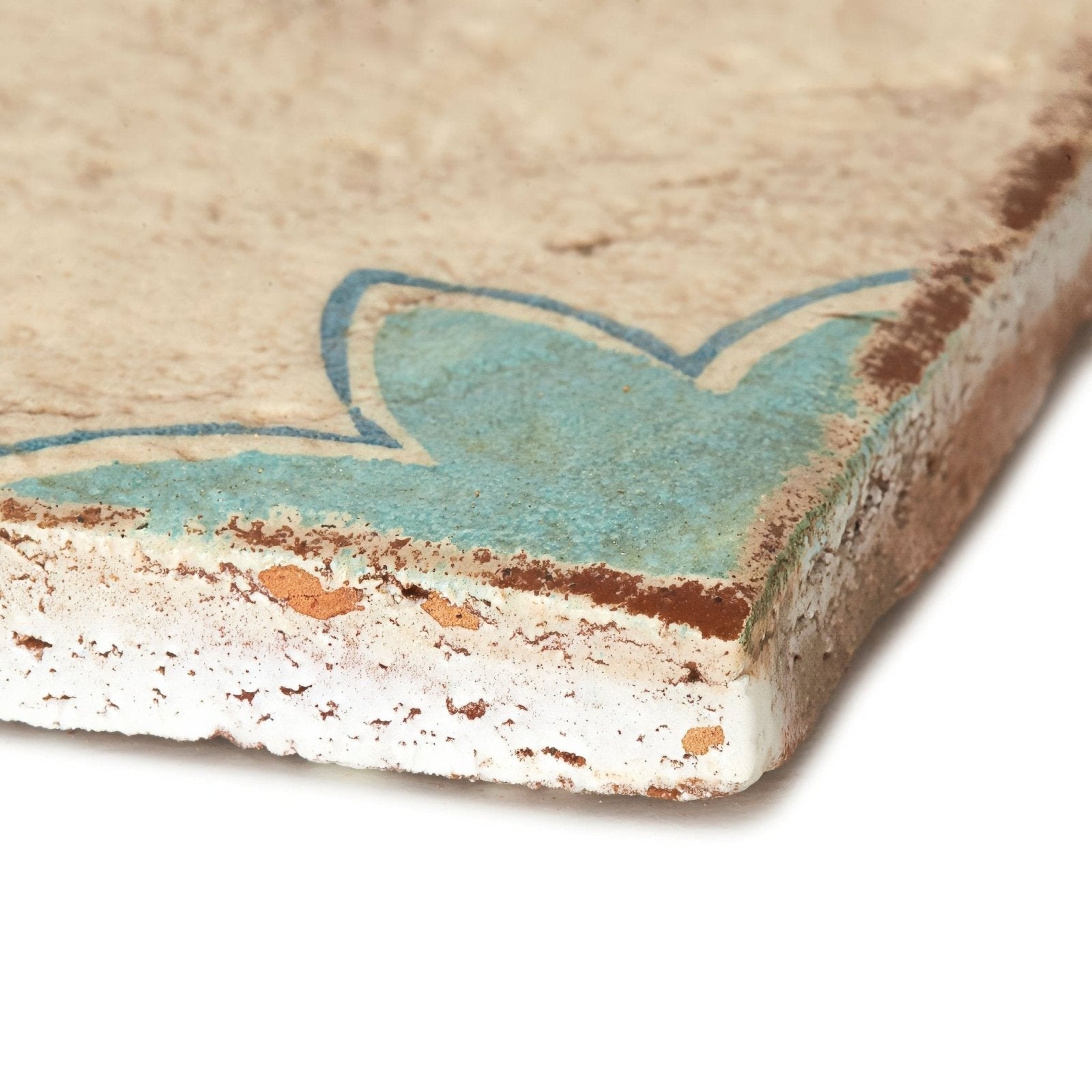 Paris Sandrine rustic beige ceramic tile with faded turquoise floral design and chipped weathered edges