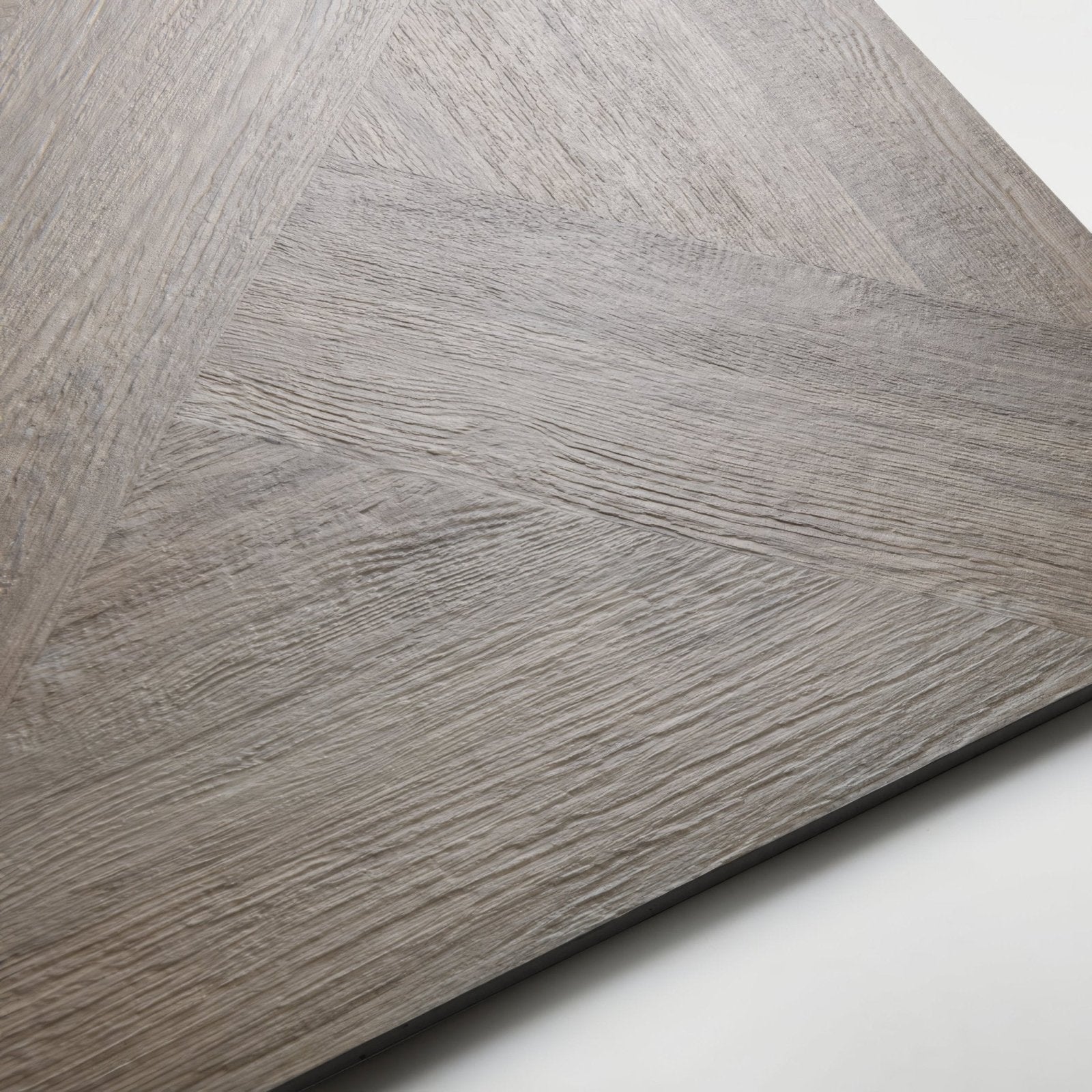 Gray wood-grain vinyl plank flooring in herringbone pattern from parquet khaki collection