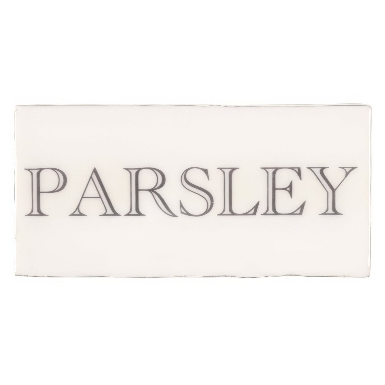 Cream-colored rectangular ceramic tile with the word parsley in dark gray serif font from Parsley in Grey on Cotton