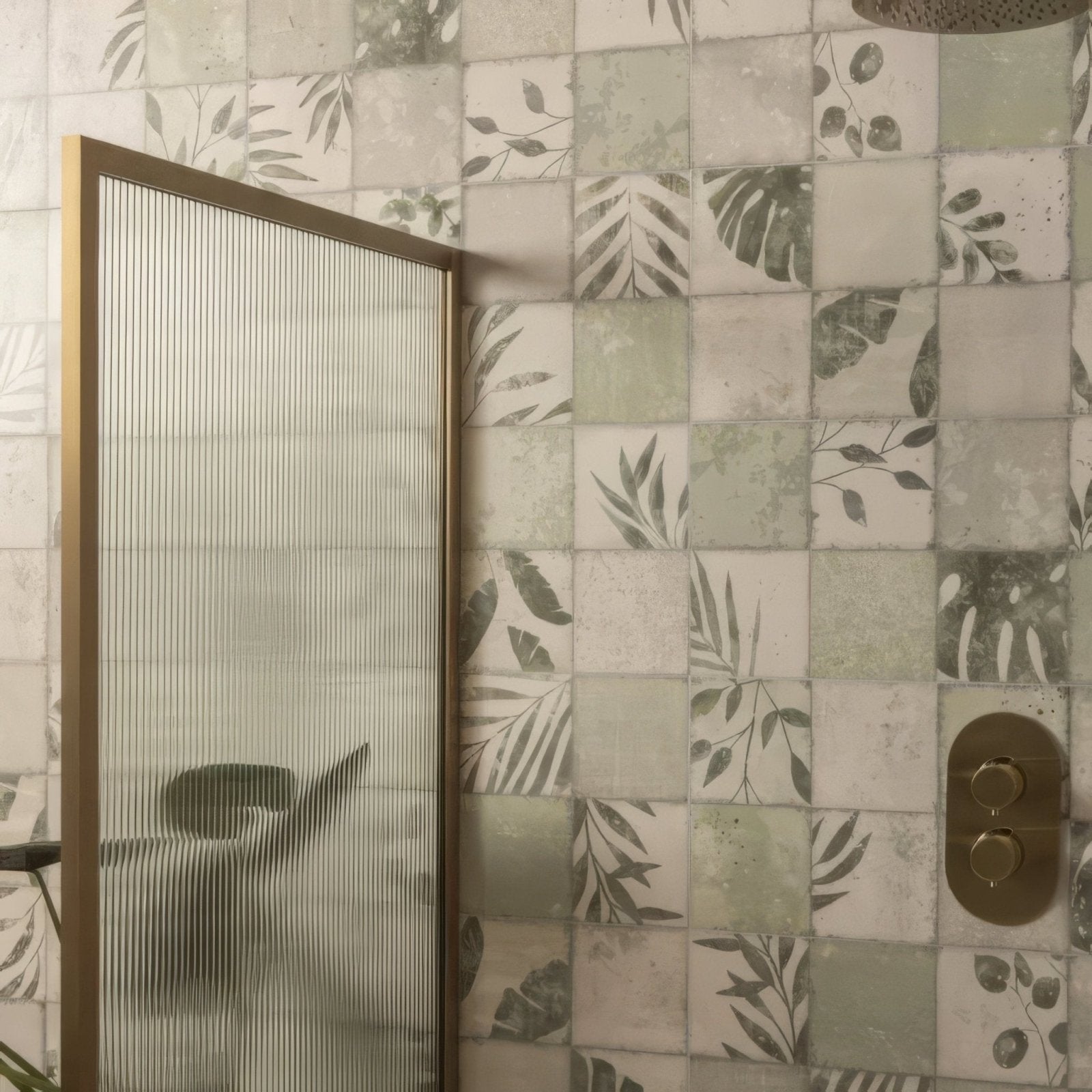 Gold-framed shower screen with vertical frosted glass panels featuring patchwork botanical ivy design 60x30cm