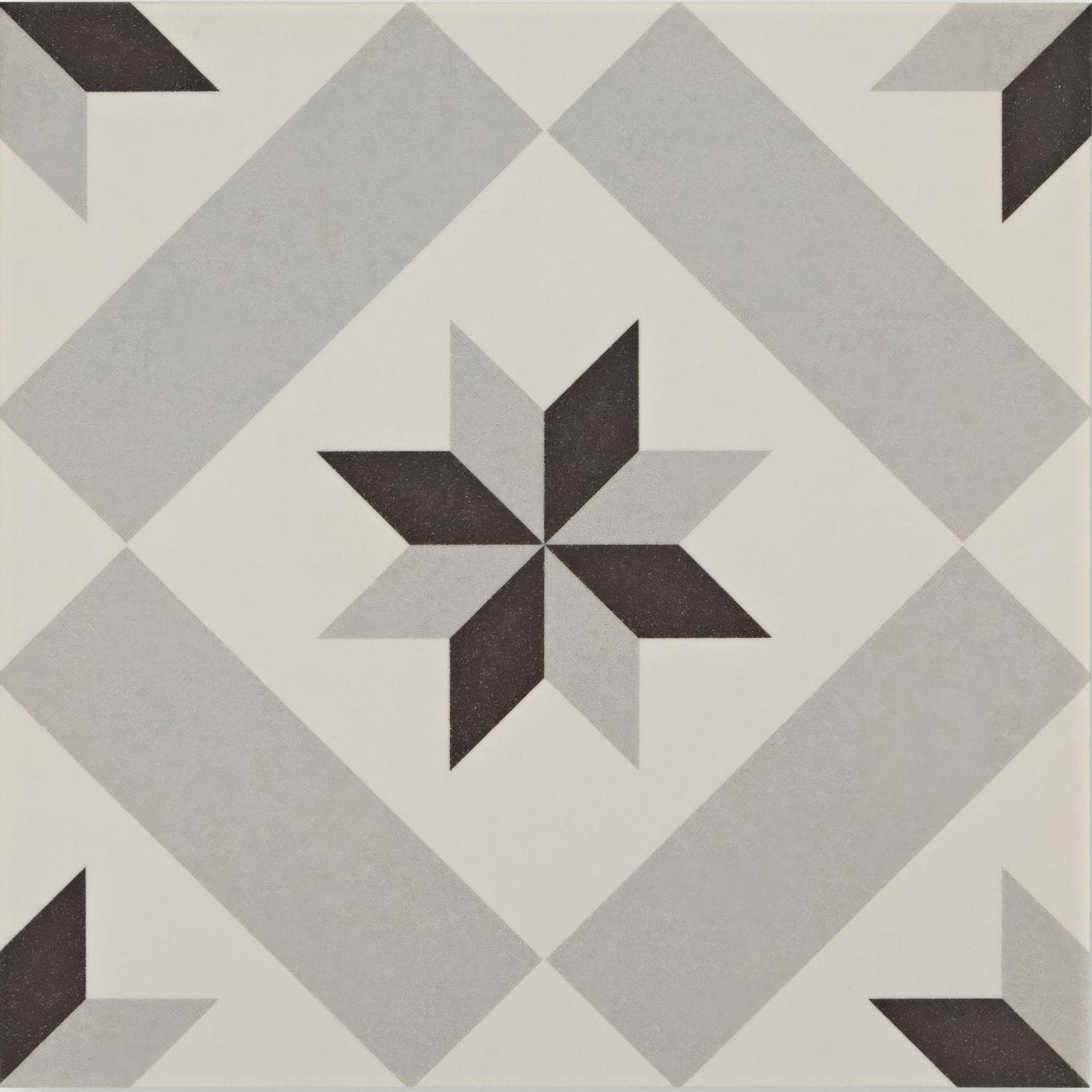 Gray and black patterned Patisserie Sucre 1 ceramic tile featuring a geometric floor design with a central star