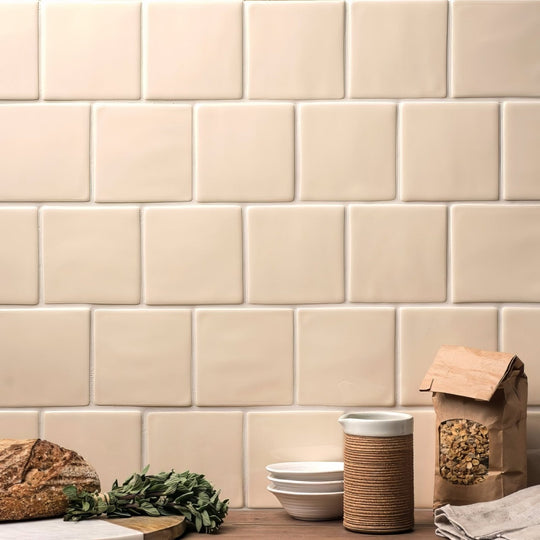 Cream-colored square ceramic pearl field tile with matte finish arranged in classic subway pattern
