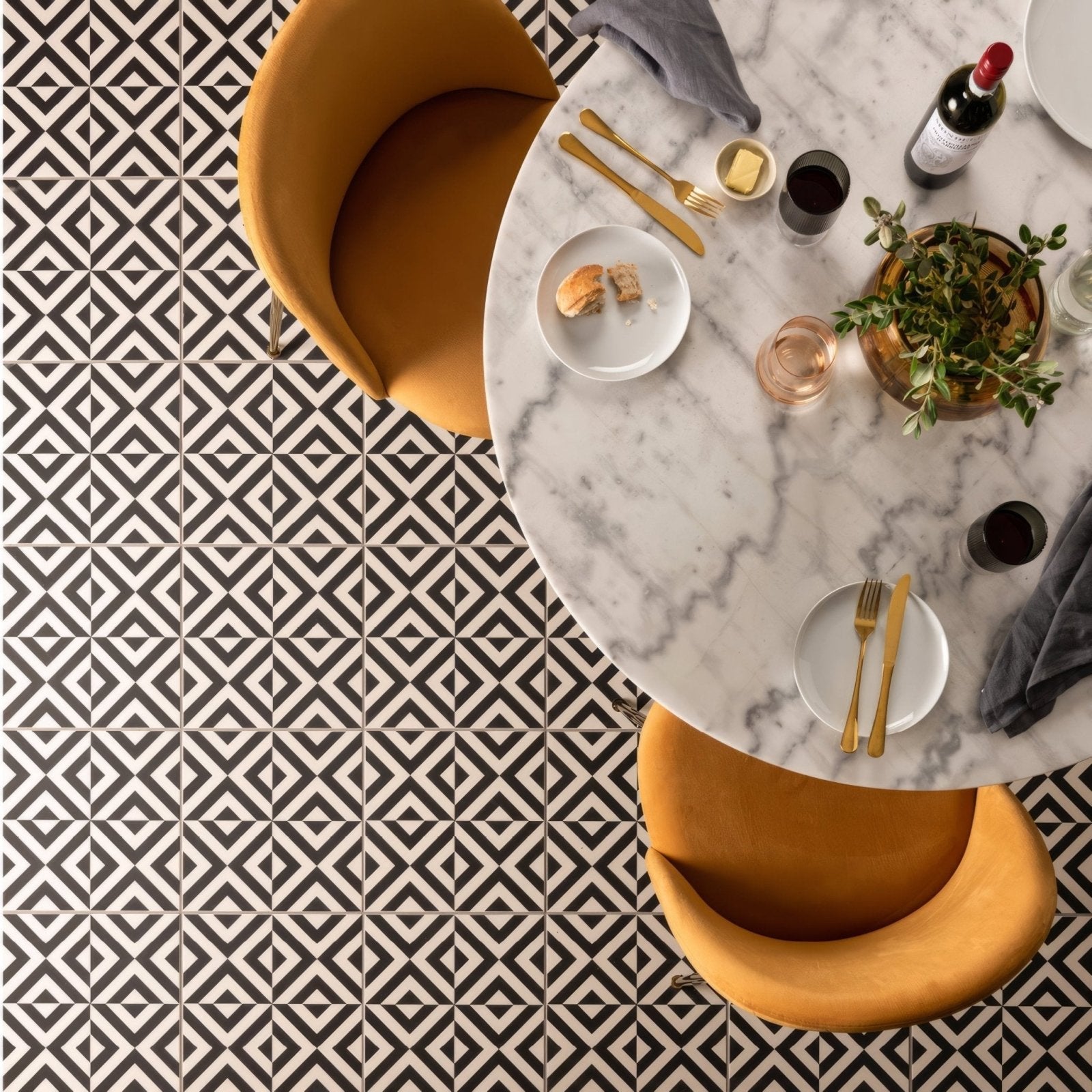 Penshaw black on chalk marble tabletop with gold cutlery and a bottle of wine for elegant dining settings