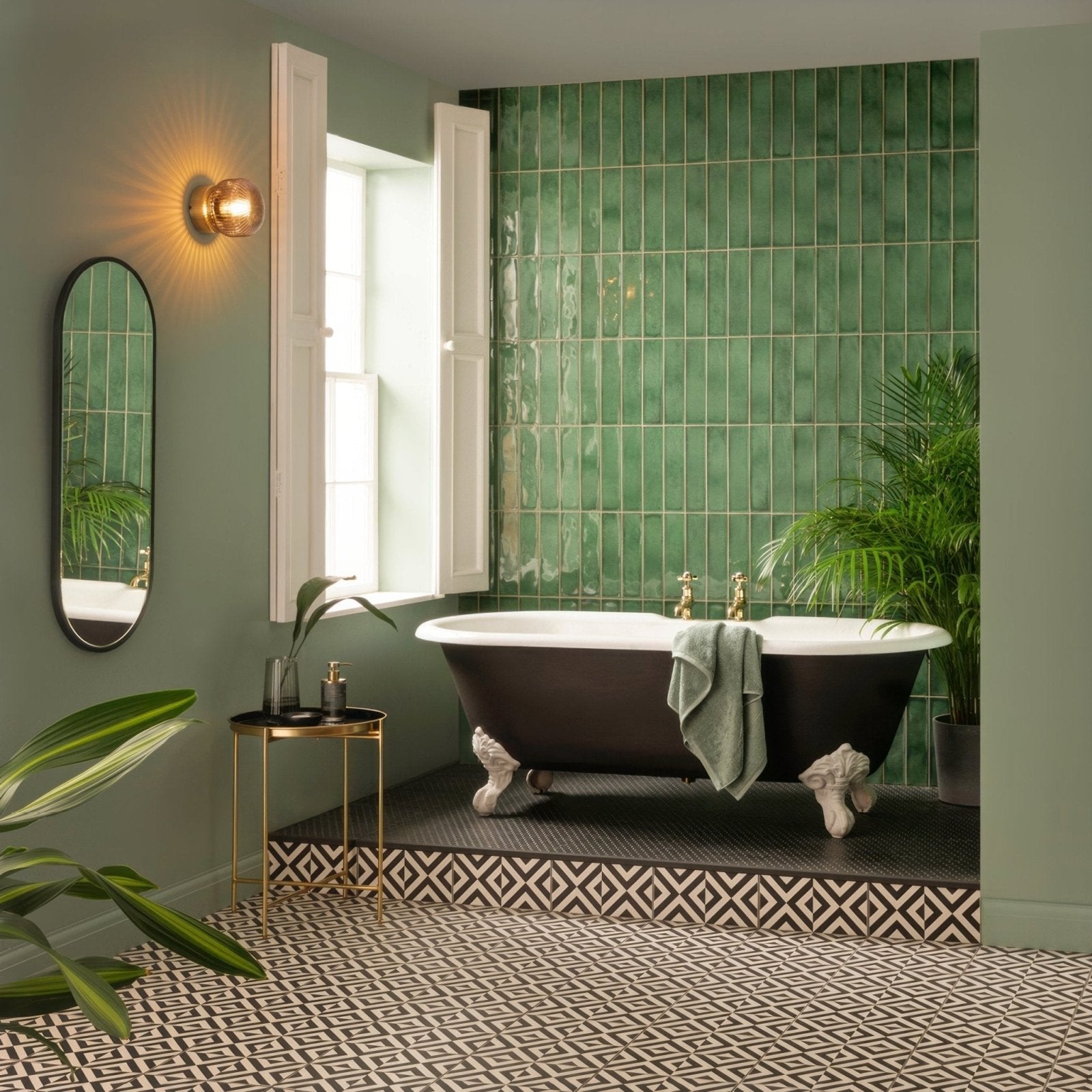 Penshaw black on chalk clawfoot bathtub with black exterior white porcelain interior and gold-toned fixtures
