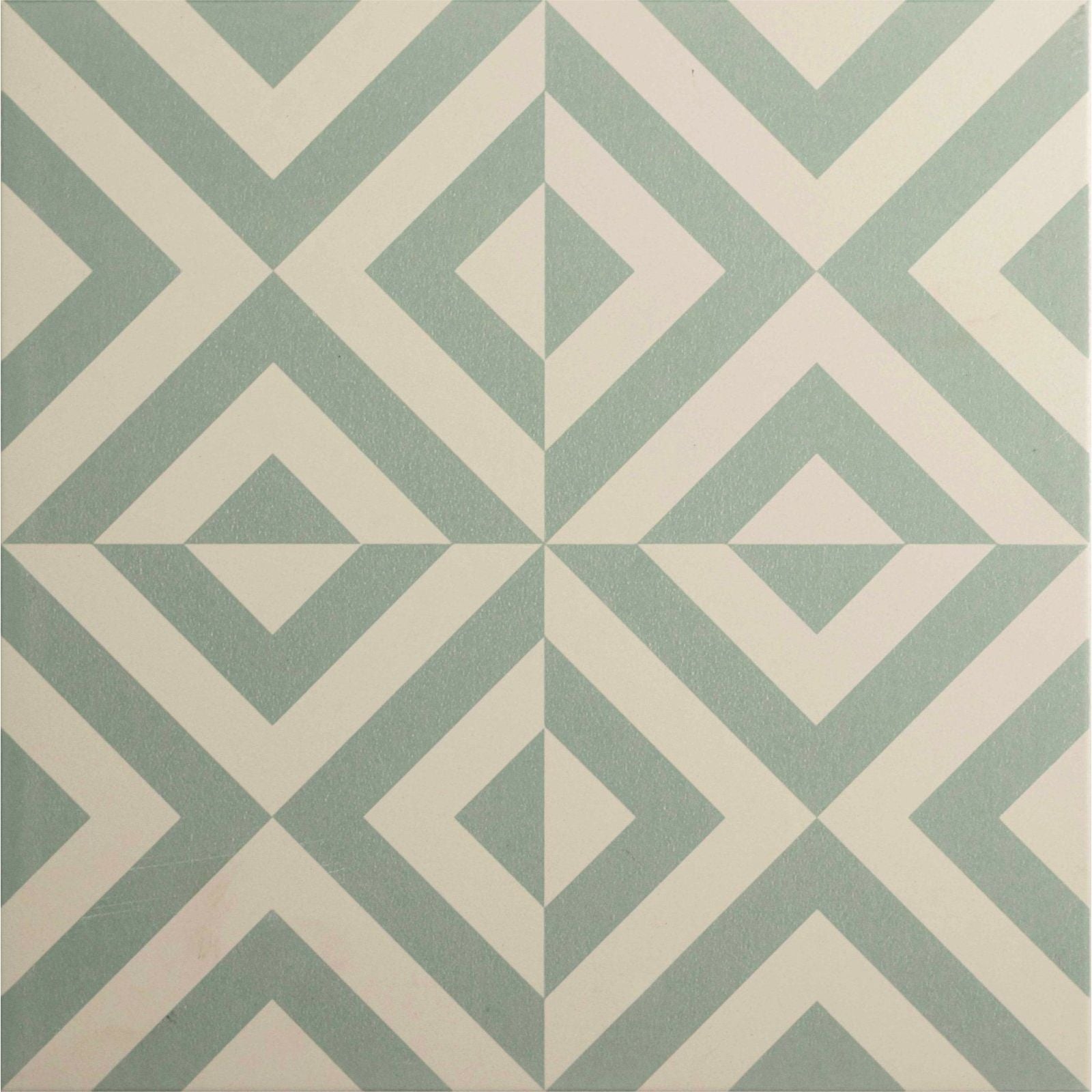 A square ceramic tile penshaw teal on chalk with a geometric pattern of intersecting light green and cream chevrons