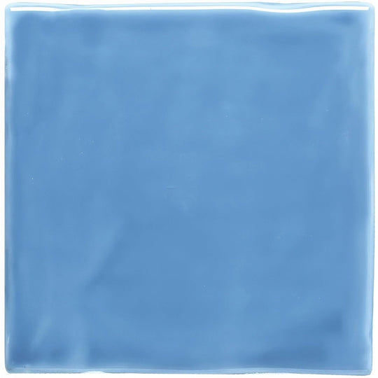 A square glossy blue ceramic tile with a smooth slightly reflective surface called periwinkle field tile
