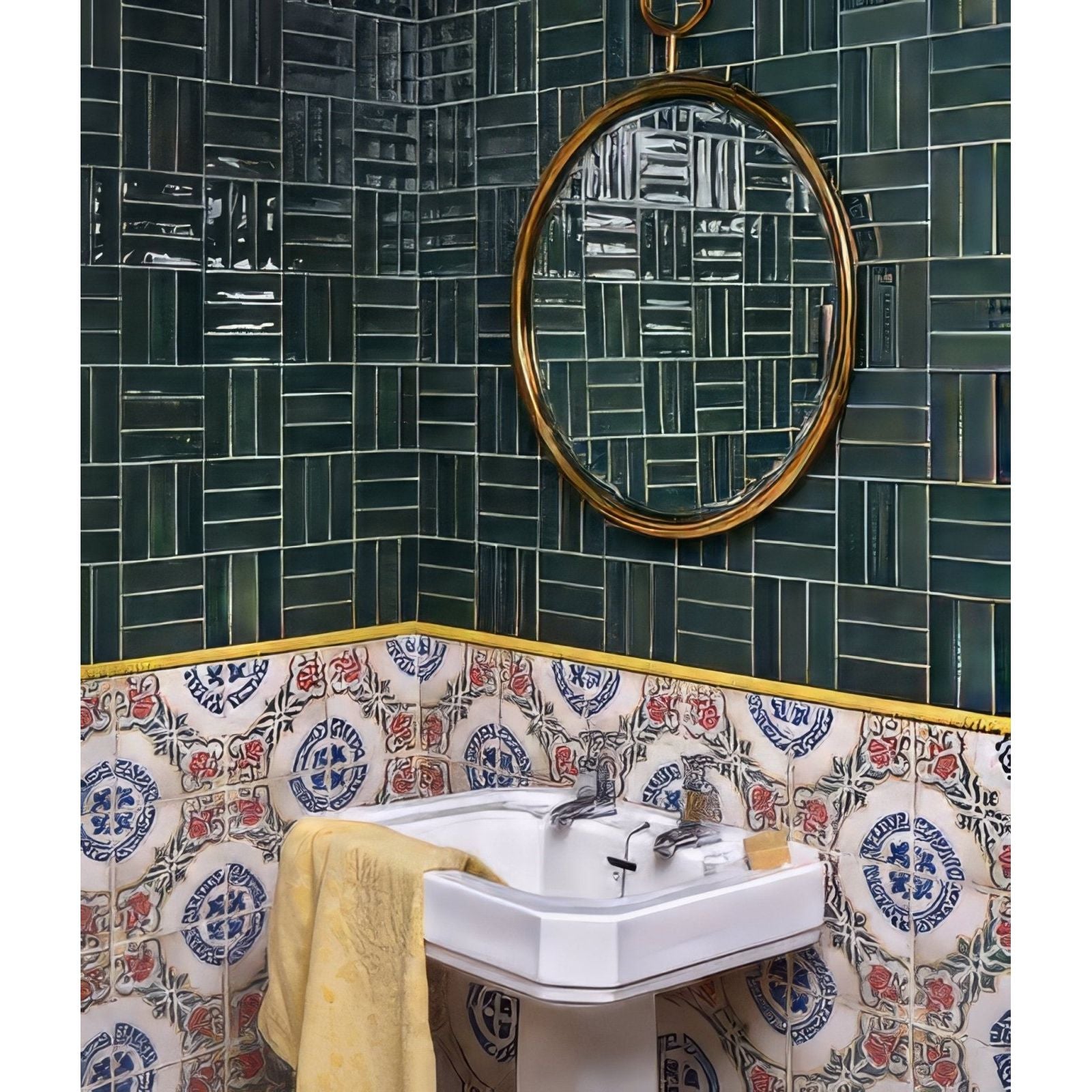 Round gold-framed mirror hanging above a petite porcelain gloss green white pedestal sink in bathroom setting