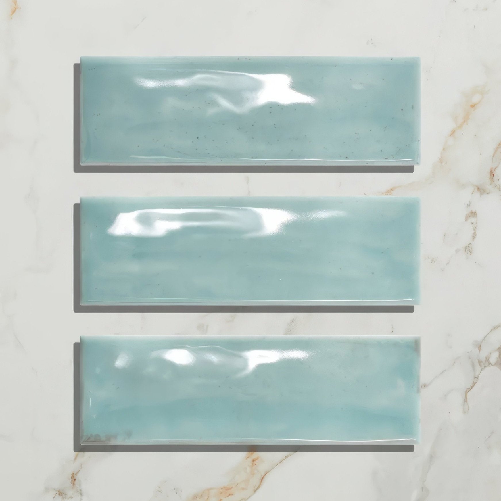 Three glossy turquoise petite porcelain gloss sky ceramic tiles arranged vertically for wall or surface use