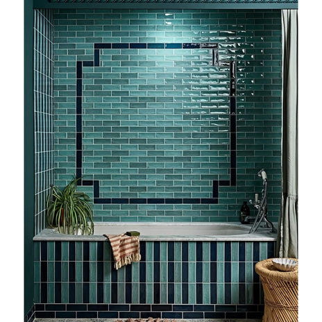 Petite porcelain gloss sky teal glass subway tiles with a glossy finish and dark blue geometric border tiles