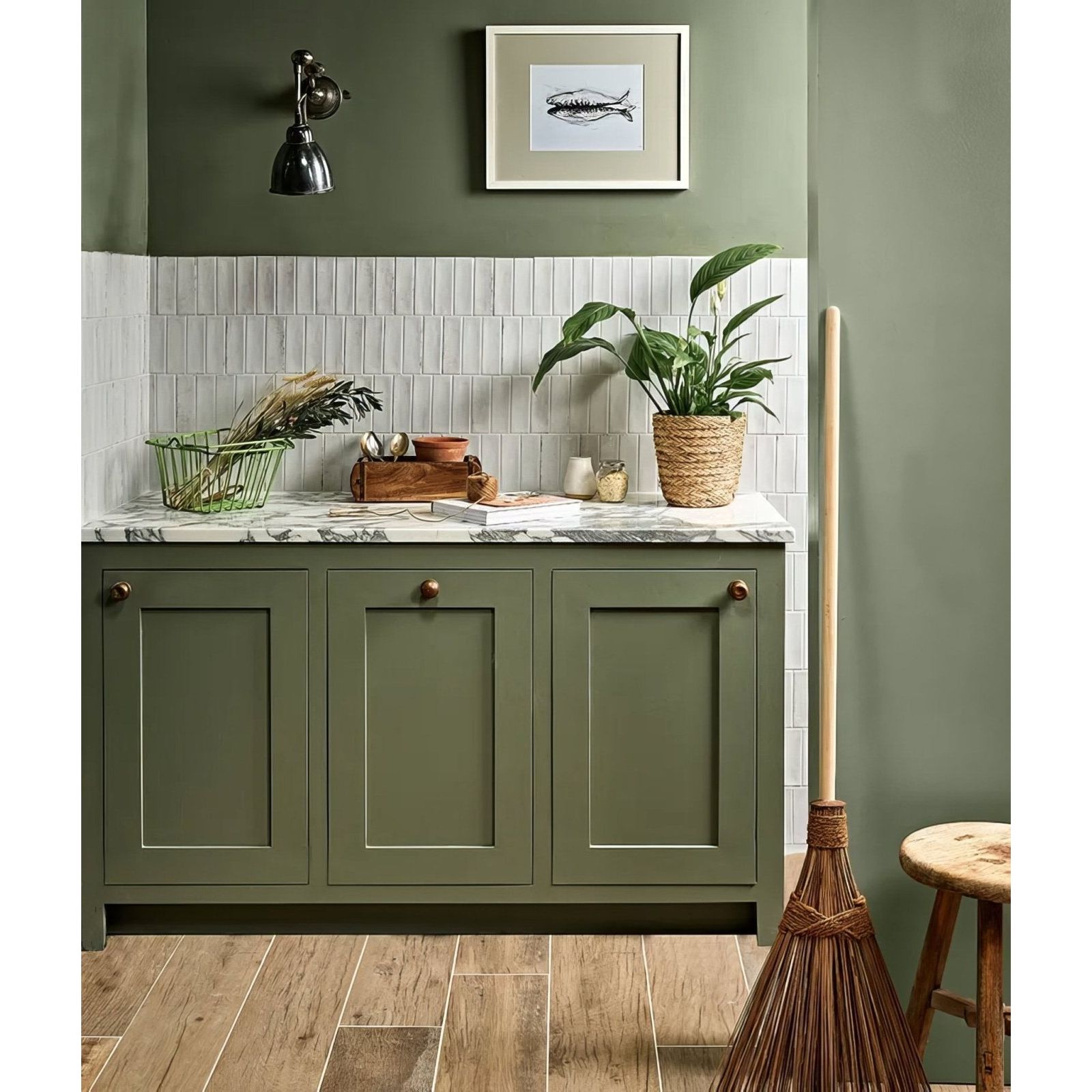 Petite porcelain gloss white kitchen cabinets with olive green shaker-style doors brass knobs and marble countertop